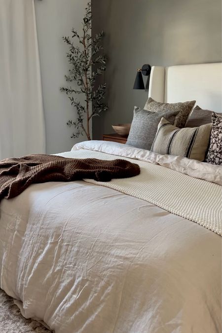 Bedroom decor, neutral bedding, Tilly bed, upholstered headboard, upholstered bed frame, neutral bed frame, bedroom wall sconces, black wall sconces, olive tree, tree for bedroom, throw blanket, throw pillows, neutral duvet cover

#LTKhome #LTKfindsunder100 #LTKsalealert