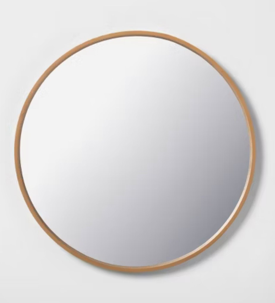 The warm tone of this round, wood mirror will add warmth to your bathroom design. 

#LTKHome
