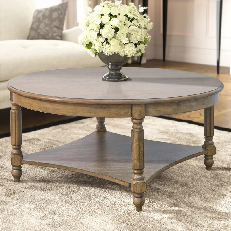This round coffee table brings a traditional, lived-in feel to your living room. Its wood constru... | Wayfair North America