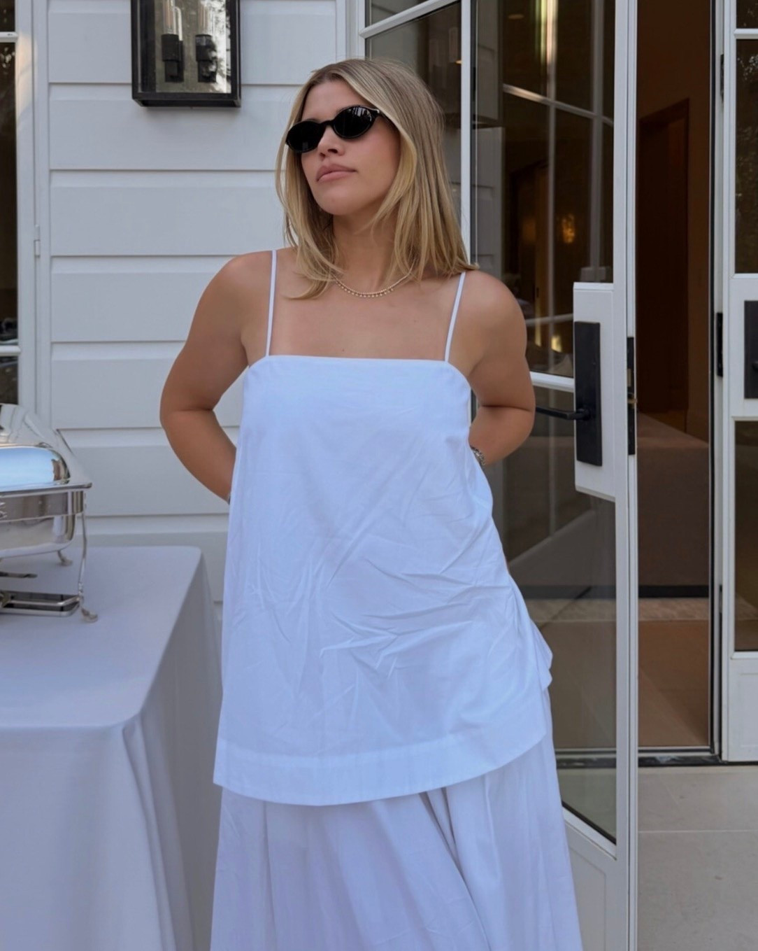 Sofia Richie white Mid-length dress in organic cotton with a voluminous A-line silhouette, straight neckline, and dual dress construction. Features in-seam pockets.

- Voluminous silhouette. If you prefer a less oversized look, we recommend sizing down