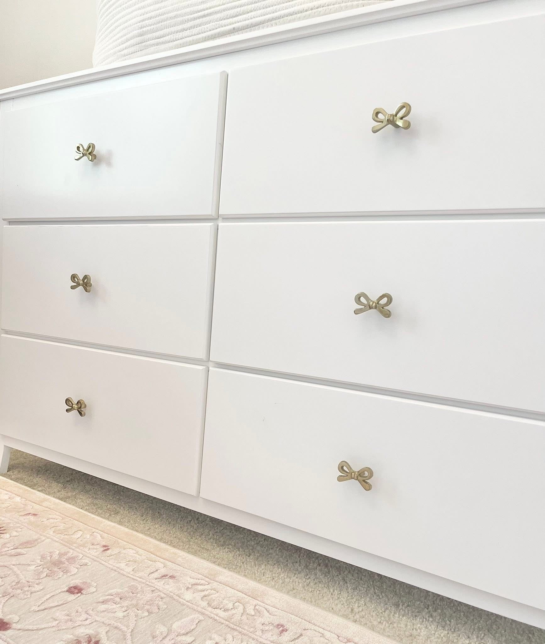 Gold bow nursery , white dresser 

#LTKSaleAlert #LTKHoliday #LTKBaby
