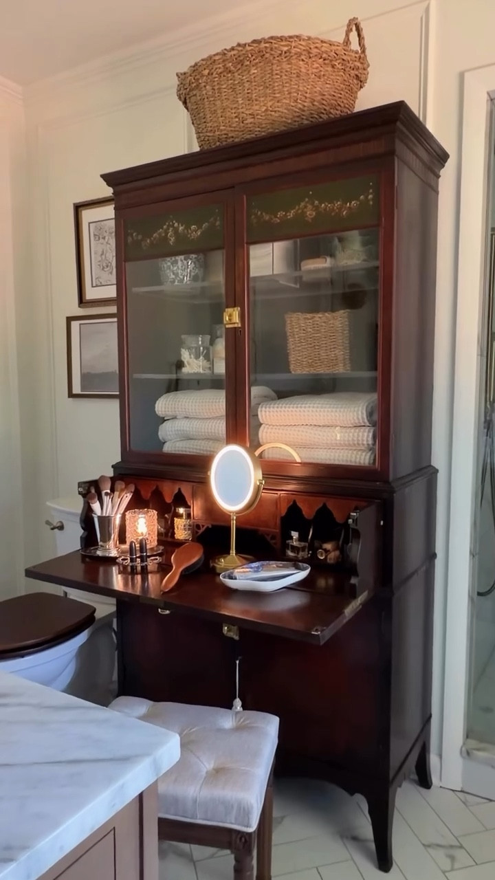 Antique secretary desk = makeup vanity + towel cabinet + hamper storage 

Who’da thought? 🤯

#makeupvanity #furnituremakeover #repurposed

#LTKBeauty #LTKHome