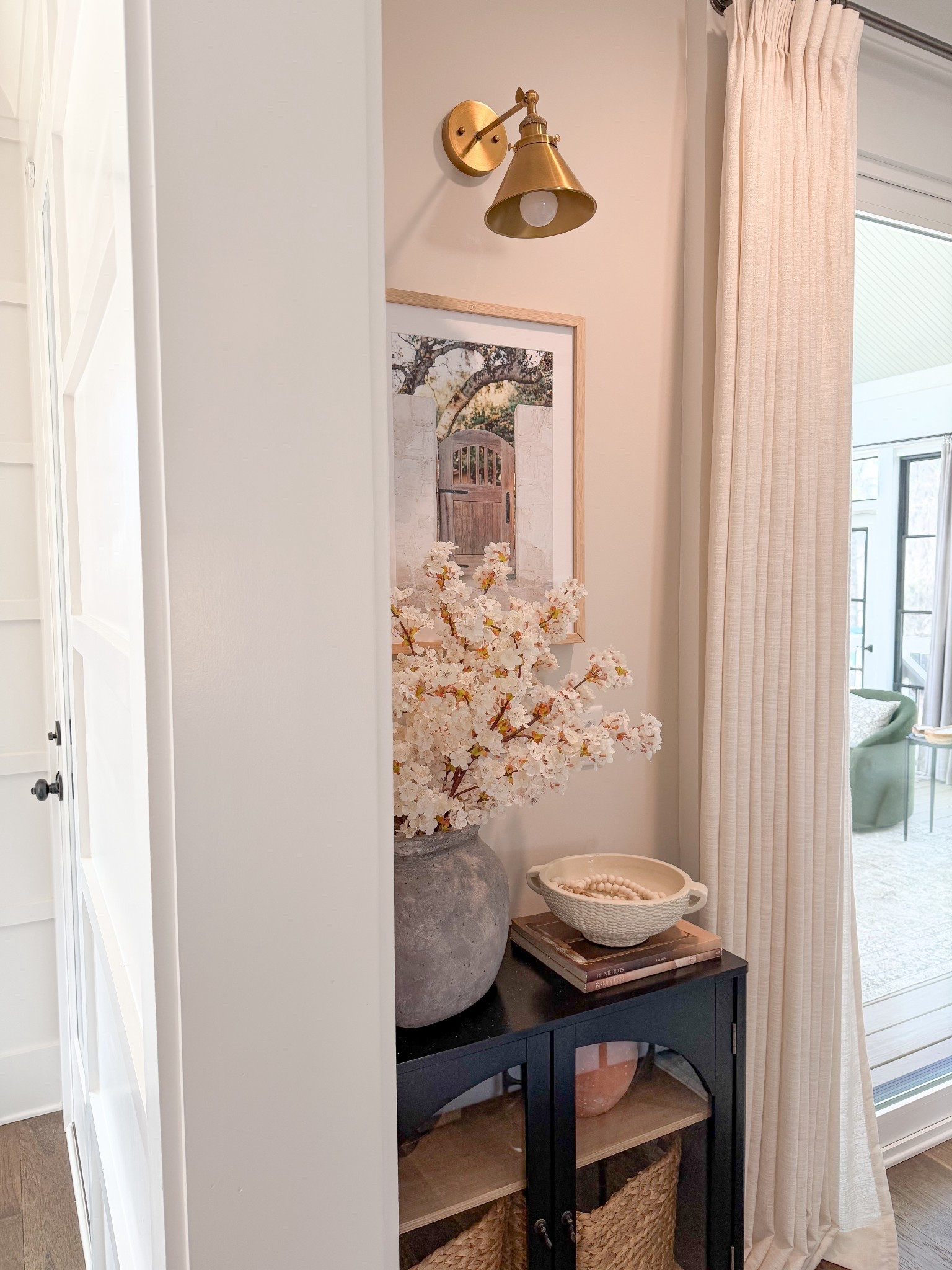 Cozy corner, corner ideas, console cabinet, black cabinet, spring florals, picture light over art

#LTKHome