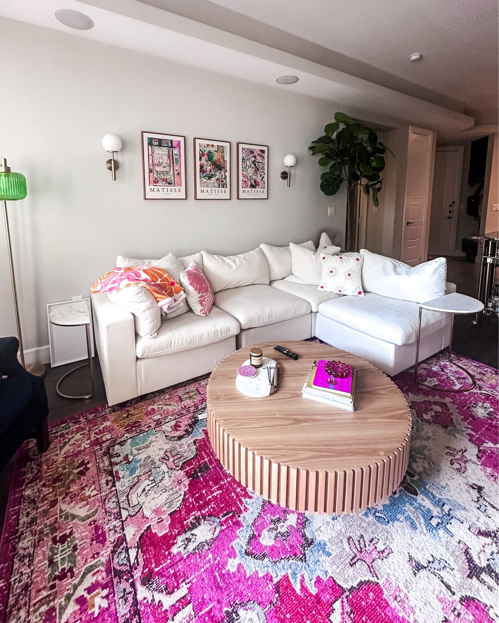 Colorful living room decor, feminine living room inspiration, mid century modern living room design, pink girly living room, white modular couch, fluted round coffee table, green glass floor lamp, Matisse wall art, pink abstract floor rug, colorful home decor 

#LTKHome #LTKFindsUnder100 #LTKSaleAlert