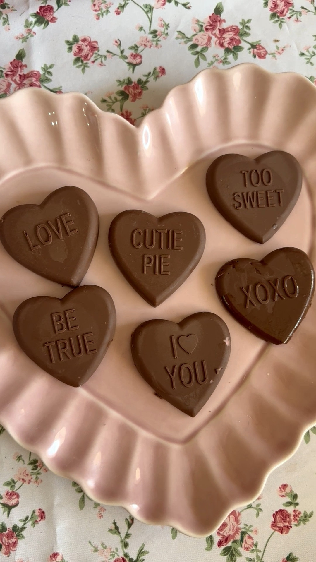Valentine’s Day decor. Homemade Valentine’s Day conversation heart candies. I used chocolate melting wafers and melted them in a double boiler on my induction stove. I then poured the melted chocolate into the conversation heart silicone molds and put them in the refrigerator for 20 minutes. They look great on my heart shaped ceramic platter and rose print tablecloth! This is perfect for Valentine’s Day, Galentine’s Day and will also make a cute gift for a loved one! The kids will love this DIY Valentine’s Day project! 💗❤️ 

#LTKFindsUnder50 #LTKfoodie #LTKHome