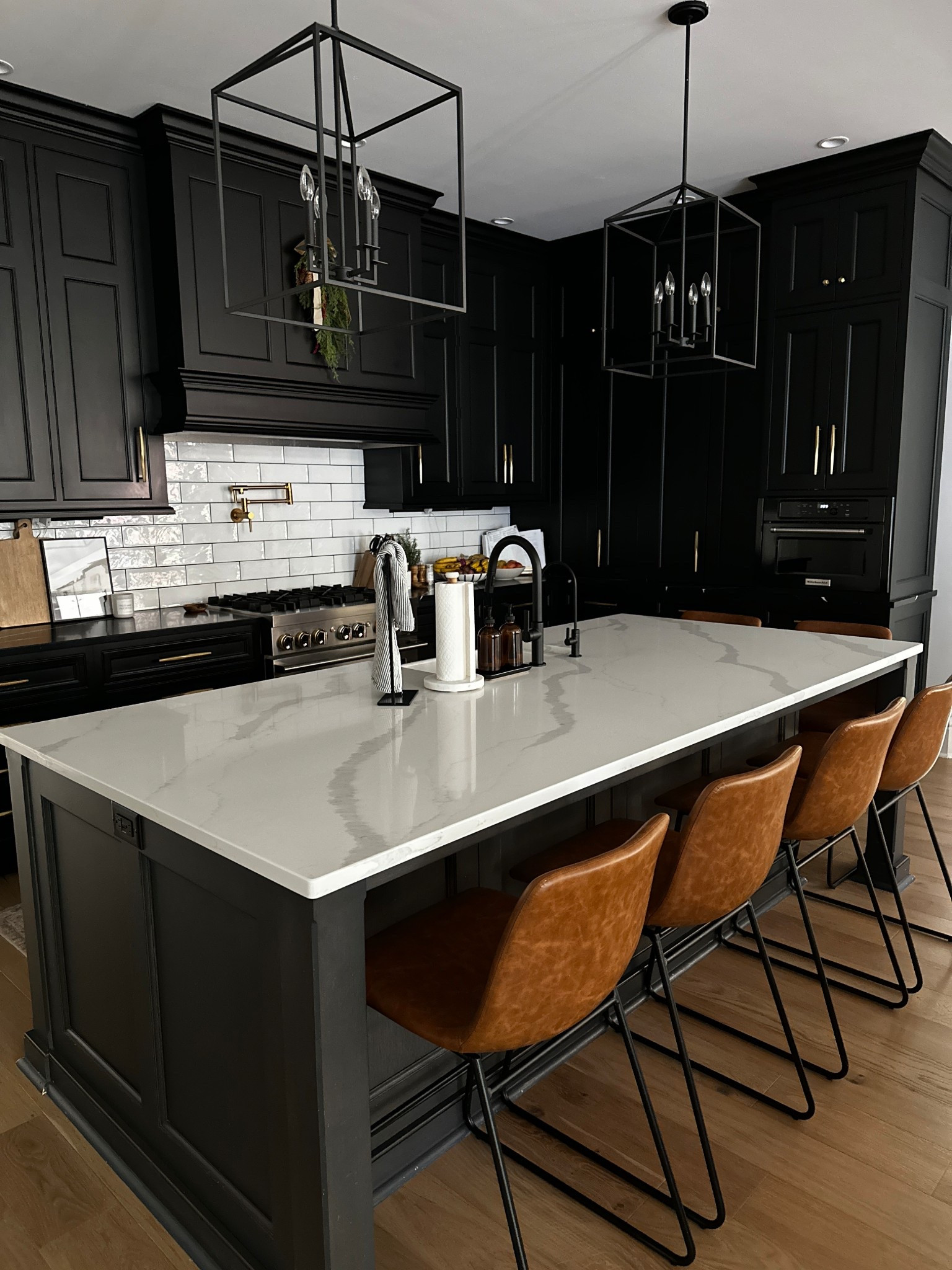 Modern farmhouse black and white neutral kitchen details / brown bar stools / black faucet black lights / white tile backsplash 



#LTKSaleAlert #LTKHome