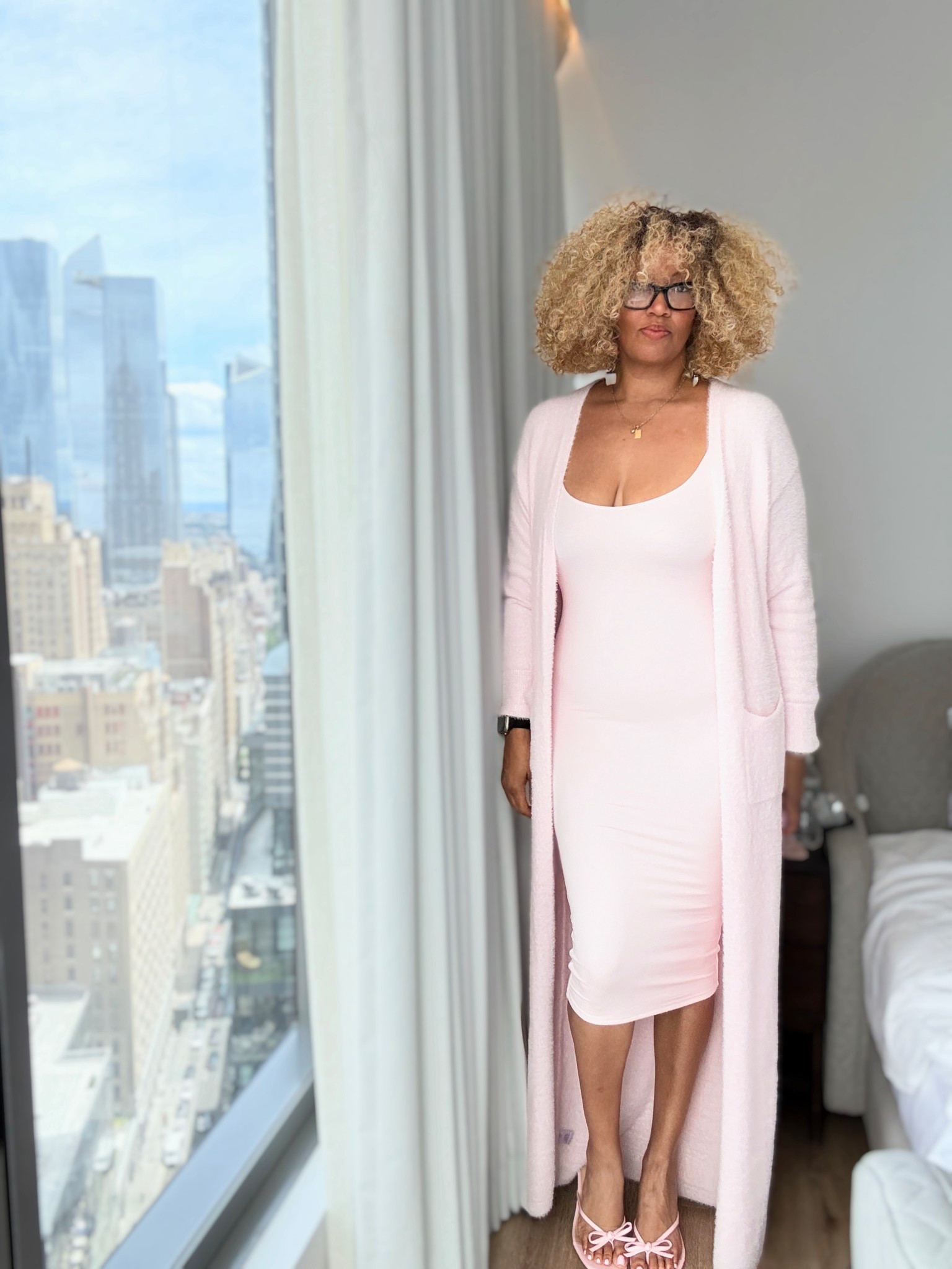 Pink birthday fit number one wearing a size medium in the dress and a size large in the sweater