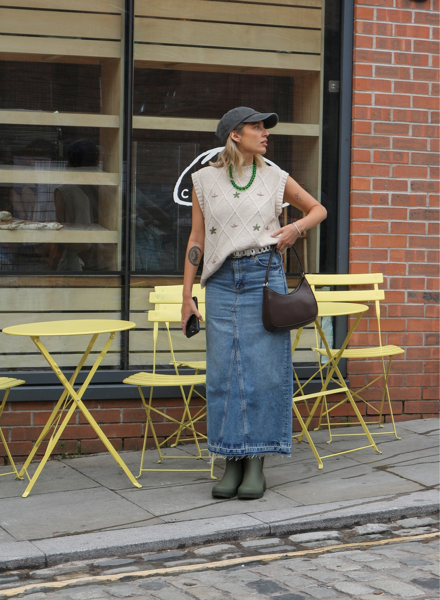Transitional outfit, embroidered vest, sweater vest, cream vest, denim skirt, maxi skirt, denim maxi skirt, green necklace, bead necklace, short wellies, ankle boots, khaki boots, baguette bag, brown bag, leather bag, M&S, H&M, Charles & Keith, Ugg, Maje

#LTKeurope #LTKSeasonal #LTKstyletip