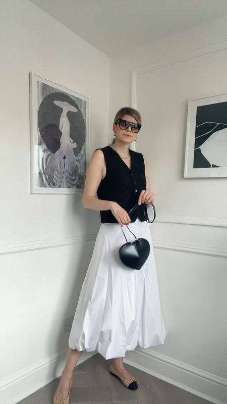Summer outfit, white skirt, white midi skirt, black waistcoat, Alaia bag, Alaia heart bag, celine shadow, celine sunglasses, chanel pumps, Chanel pumps dupe 

#LTKVideo #LTKeurope