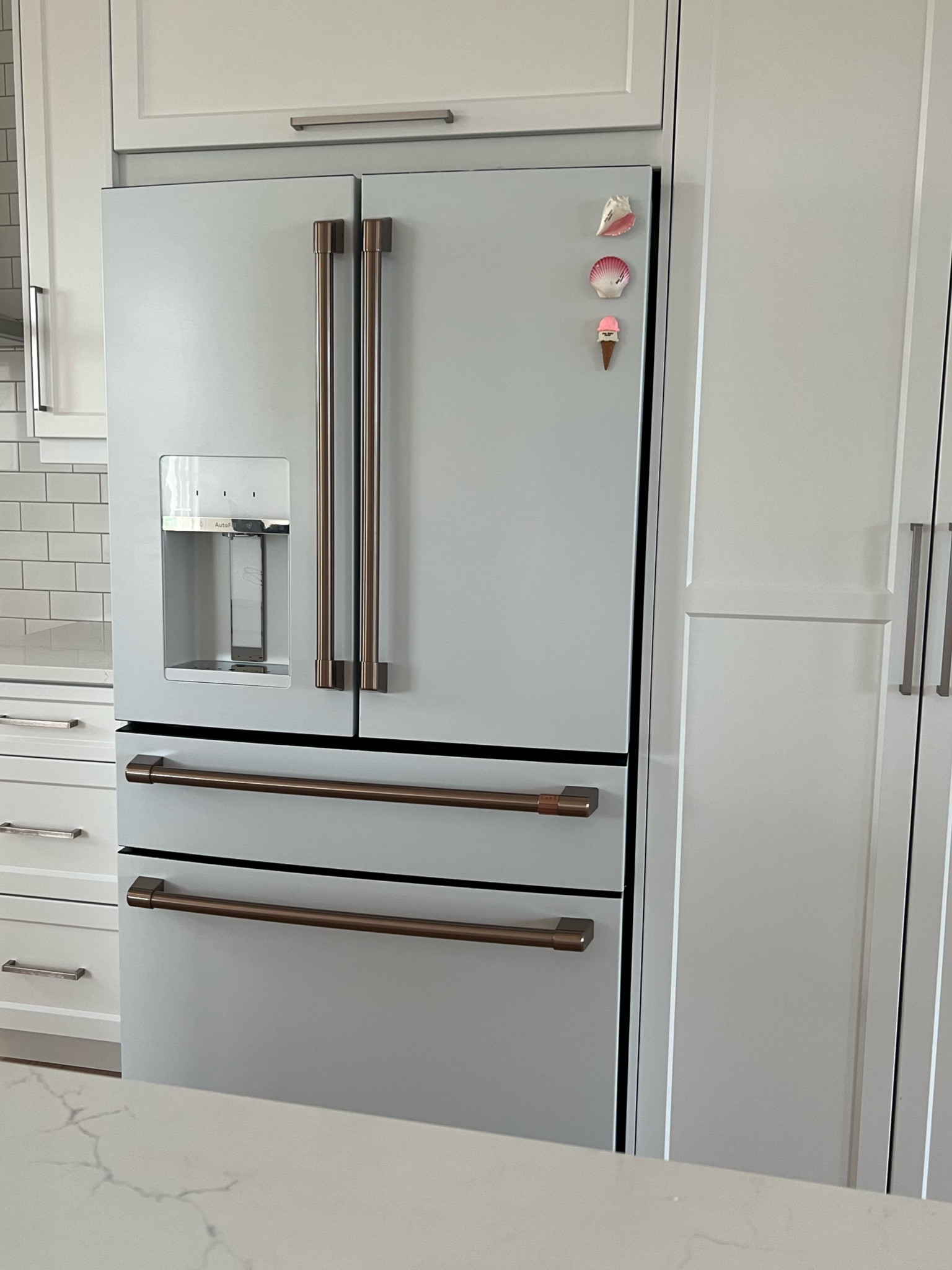 We loved this fridge so much from our previous house flip, that we HAD to get one again for our new build 🙊🤍✨ If you want a fridge with style - you’ve found it!  Also must note as a fam of 6, the center drawer that can switch between fridge or freezer mode is SO helpful with large grocery orders overflow or storing leftovers! #whiteinteriors #whitekitchen #goldhardware #cafe 

#LTKStyleTip #LTKFamily #LTKHome