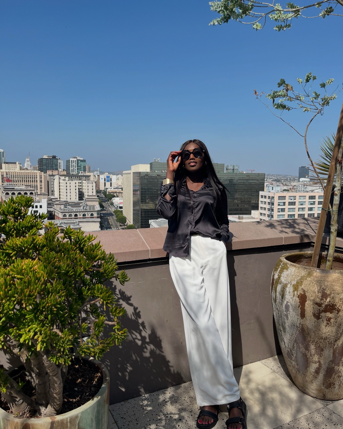 We don’t act rich 😊 we just bathe, dress nicely and enjoy the little we have. #Ootd Sunday look🤍 🖤

How’s your day going? 

PS: These white trousers are definitely a wardrobe essential. Paired it with a luxe black satin shirt and classy black sandals to create a modish look! #StyleStory 

#casualstyle #fashionblogger #ootdshare #outfitinspo #explorepage #losangelesfashion #londonfashion #summervibes #oldmoneystyle #styleinspiration