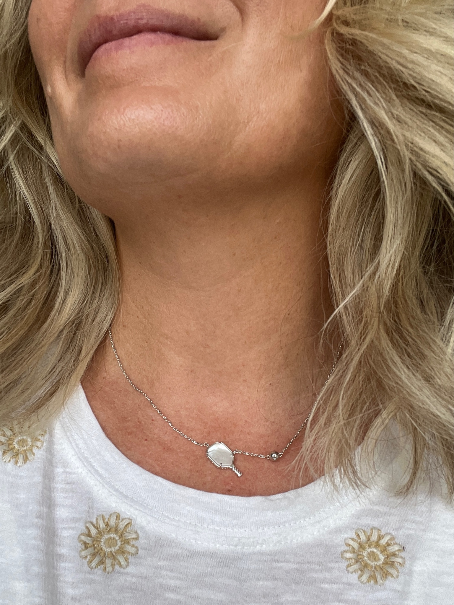 Mother-of-Pearl pickleball necklace; available in silver or gold finish. 