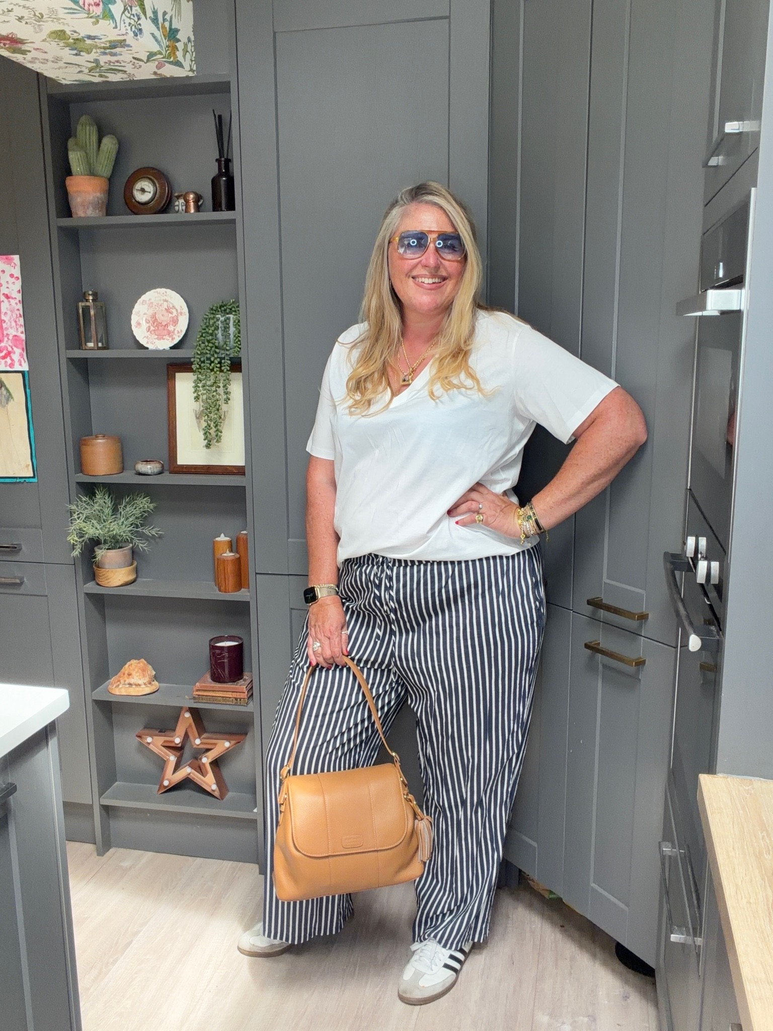 Striped trousers, white T-shirt, tan handbag, sambas, sunglasses

#LTKsummer #LTKplussize #LTKstyletip