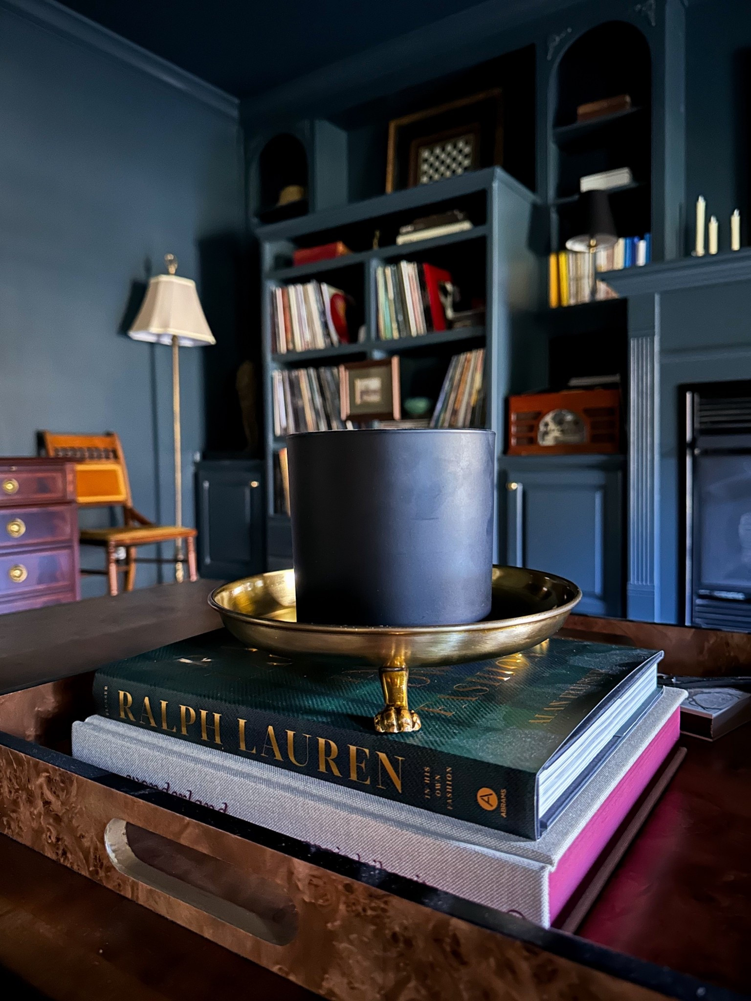 Welcome to my cozy, moody home library — layered with deep paint tones, vintage books, and brass accents for that collected look. This space feels equal parts sophisticated and inviting, the perfect example of dark and moody home office inspiration. If you love traditional home decor, built-in shelving ideas, or classic interior design, everything here leans timeless and intentional. Shop the look: brass bowl, Ralph Lauren coffee table book, and tray styling essentials.