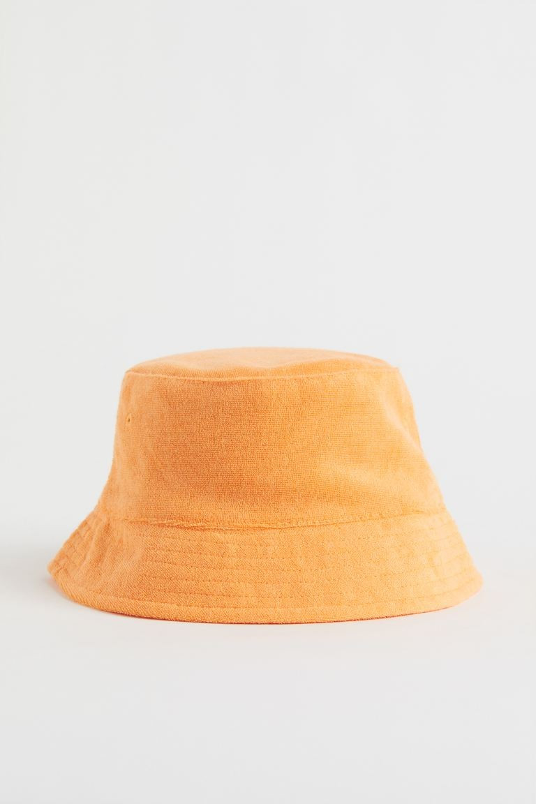 Conscious choice  Bucket hat in soft terry with a sloped brim, embroidered eyelets at side, and l... | H&M (US + CA)