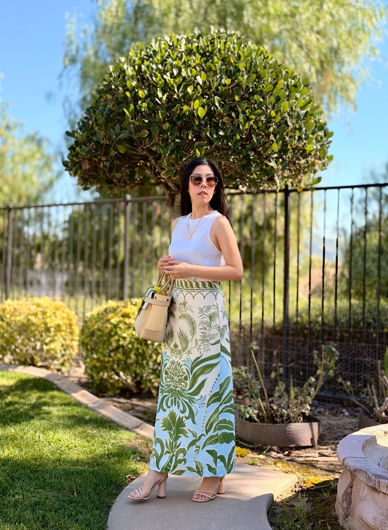 Everything in my closet used to be mini. From skirts to shorts, it was all way above my knee. However, as I’ve matured, I find myself gravitating towards less revealing looks. I recall not being the midi style’s biggest fan but now, it’s my preferred cut. I got this floral silk satin midi skirt as season 3 of The White Lotus began and every time I look at this, it transports me to a tropical place. I wanted to keep the focus on the skirt so I kept everything else simple. This ivory silk sleeveless top offers a subtle contrast to the cream color on the skirt but they both tie into my satchel. 

#midiskirt #whitelotus #modeststyle #silktop #slipskirt #springstyle #ootd #flowerskirt #aviators 

#LTKootd #LTKPetite #LTKSaleAlert