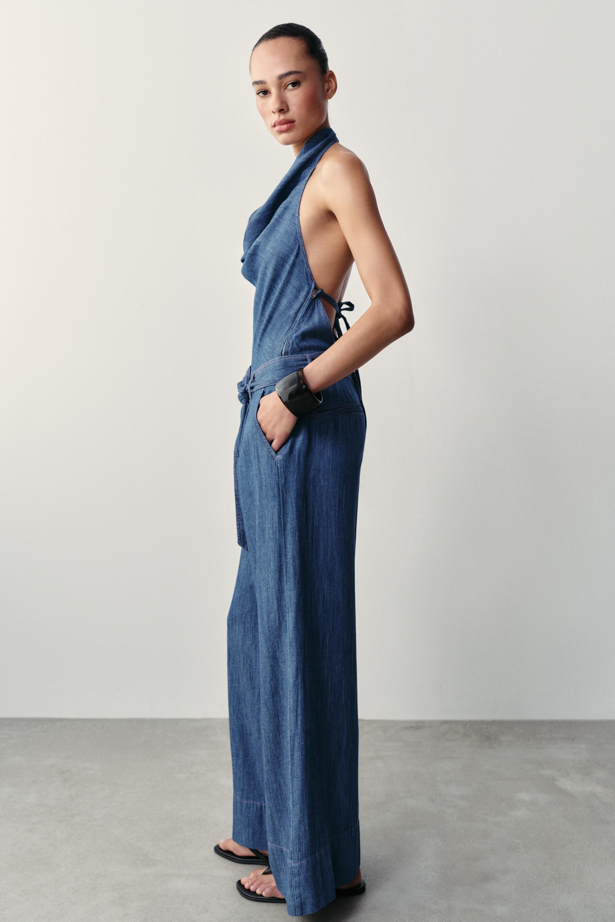 Halter neck jumpsuit with an open back. Features a matching fabric belt with contrast topstitchin... | Zara IT