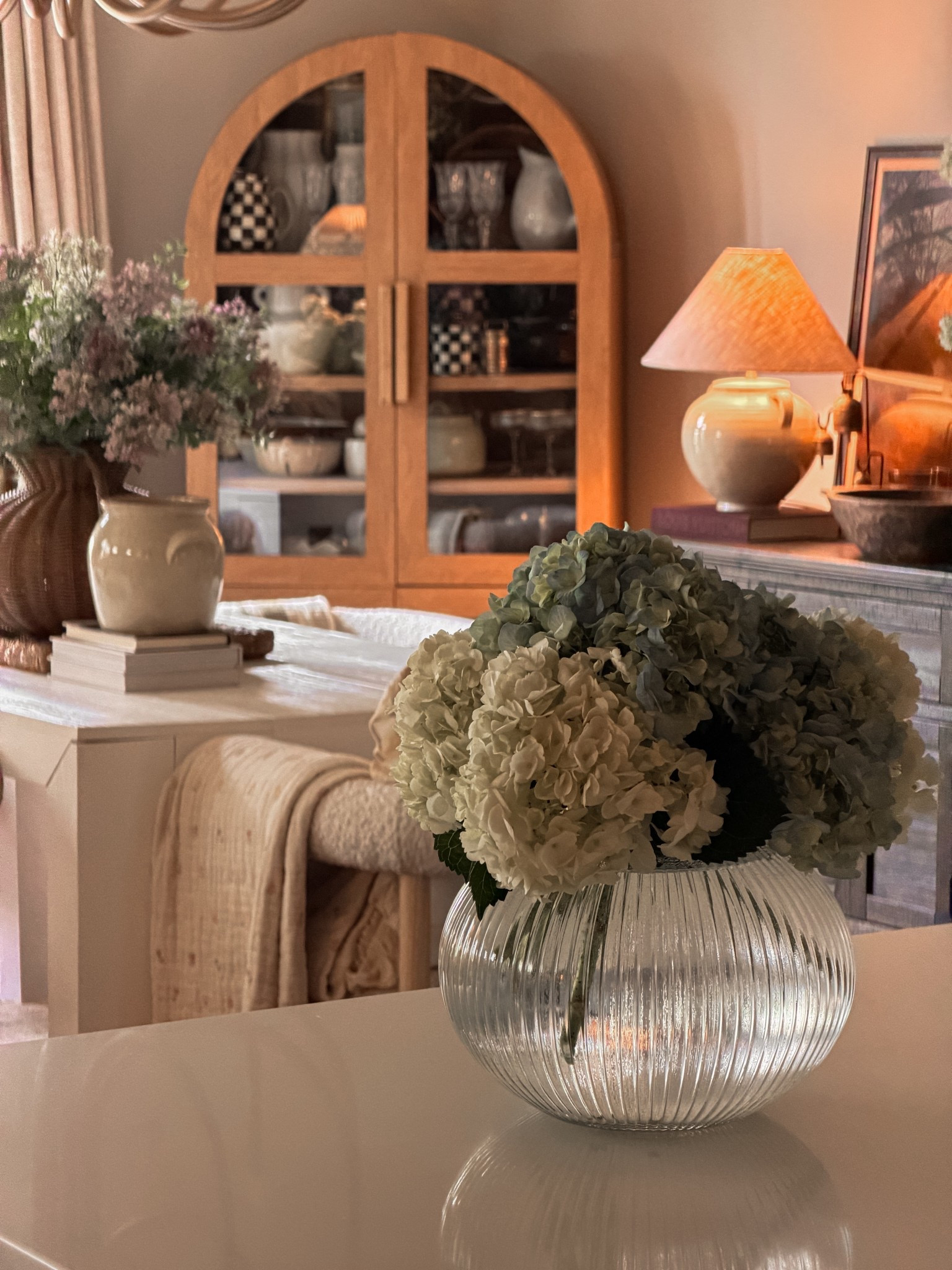 #ArchedCabinet #OrganicModern #CoastalGrandmother #RibbedGlassVase #Hydrangeas #SpringDecor #LightWoodFurniture #CrockVase #TableStyling #DiningRoomInspo #NeutralHome #WarmMinimalism #InteriorDetails #HomeDecorFinds #AmazonHome #LTKHome #EtsyHome #StylingTips #SereneSpaces #PleatedLampshade #CeramicLamp #TexturedVase #AestheticHome #FloralArrangement #BuffetStyling #HutchDecor #DreamHome #ModernTraditional #ClassicInterior #CozyElegance #HomeInspiration #DecorCrush #SophisticatedStyle #InteriorDesignIdeas #NeutralPalette #WovenTextures #SpringAesthetic #MorningLight #HouseBeautiful #MyCuratedHome

#LTKHome #LTKSeasonal