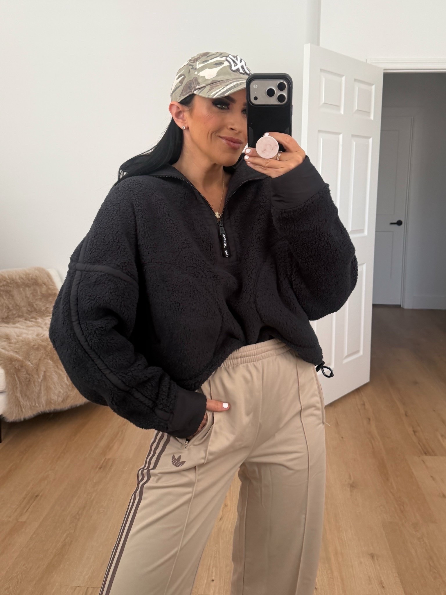 Adidas firebird loose track pants in the color stone khaki / earth strata wearing size small. Free people Mountain high half zip fleece in black wearing size small 