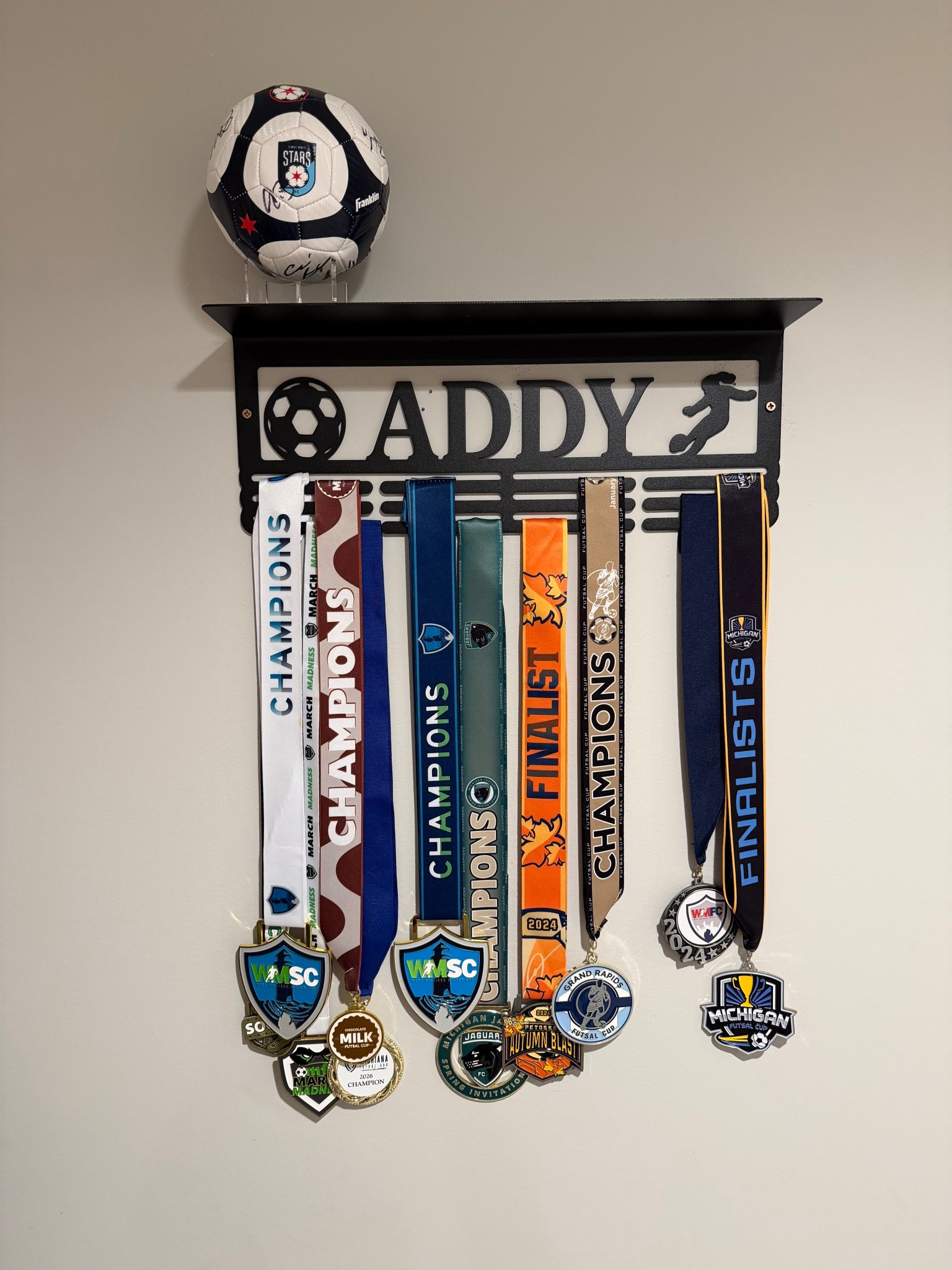 Sports medal display and trophy shelf for soccer players 