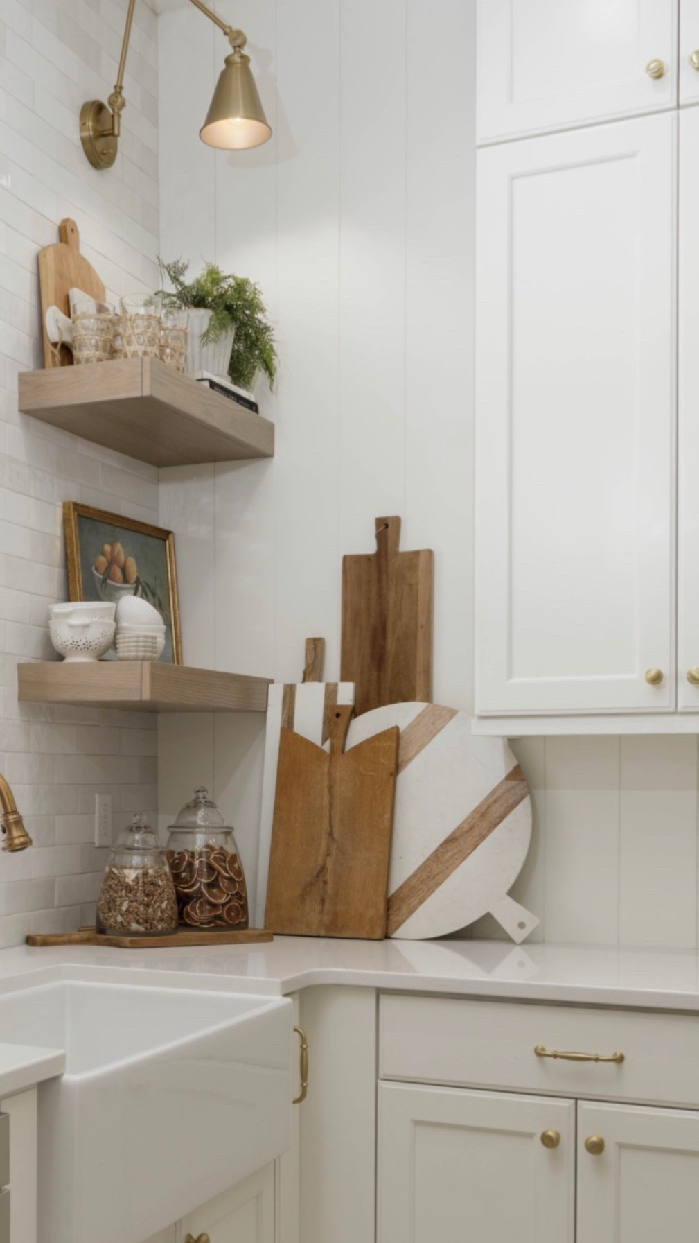 Floating shelves, warm wood tones, and a little brass lighting make this space feel cozy and collected.

#LTKHome