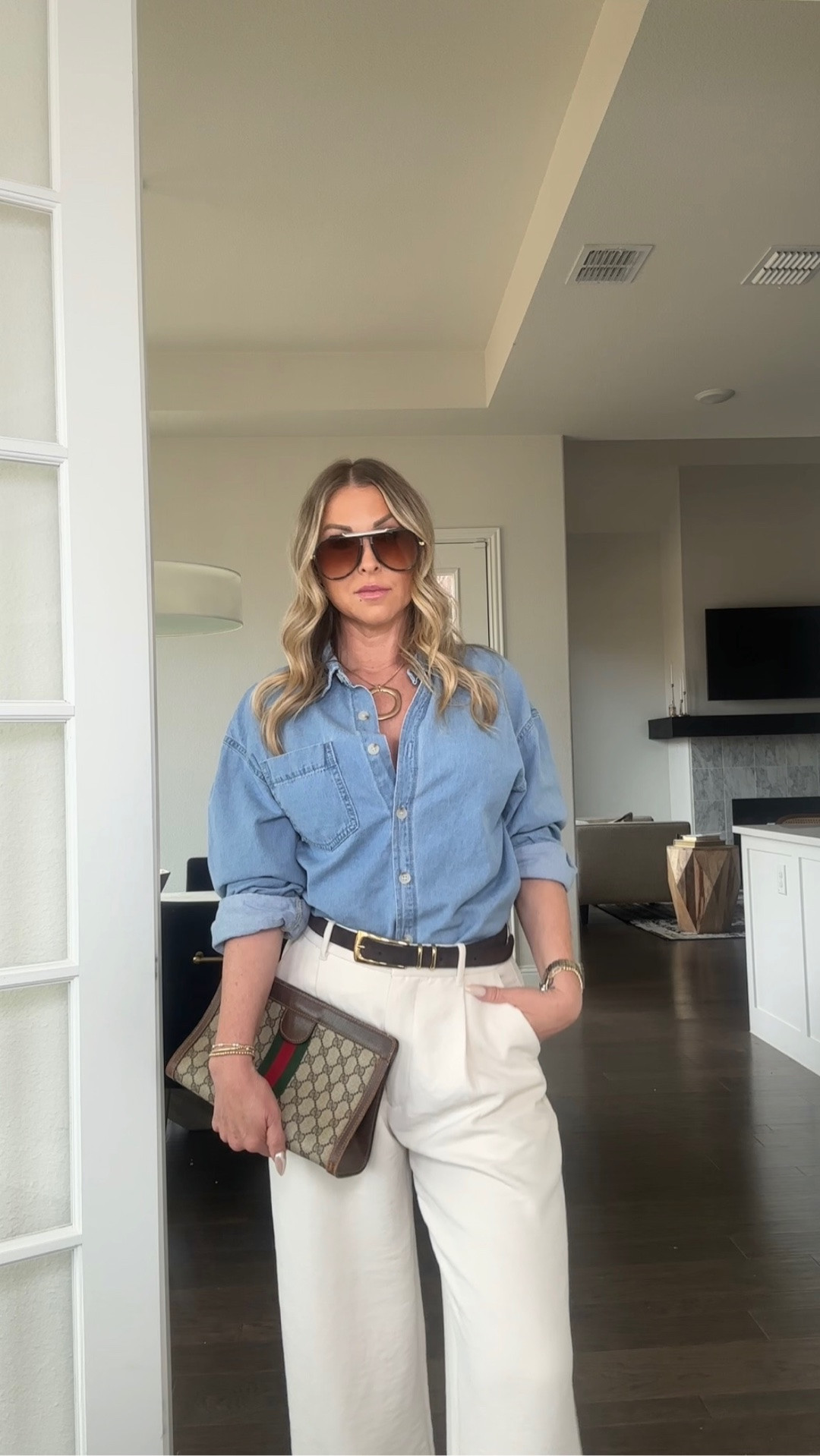 Wearing one of my favorite everyday formulas—an easy button-down paired with tailored trousers, styled with intentional details to elevate the entire look.

The belt defines the waist, the statement necklace adds interest, and the oversized sunglasses instantly make it feel polished. Finished with a structured clutch for that high-low balance I love.

This is the kind of outfit I come back to again and again—simple, wearable, and quietly elevated for real life.

#LTKstyle #LTKover40 #LTKworkwear #LTKfinds #LTKfashion

#LTKgrwm #LTKootd #LTKSeasonal