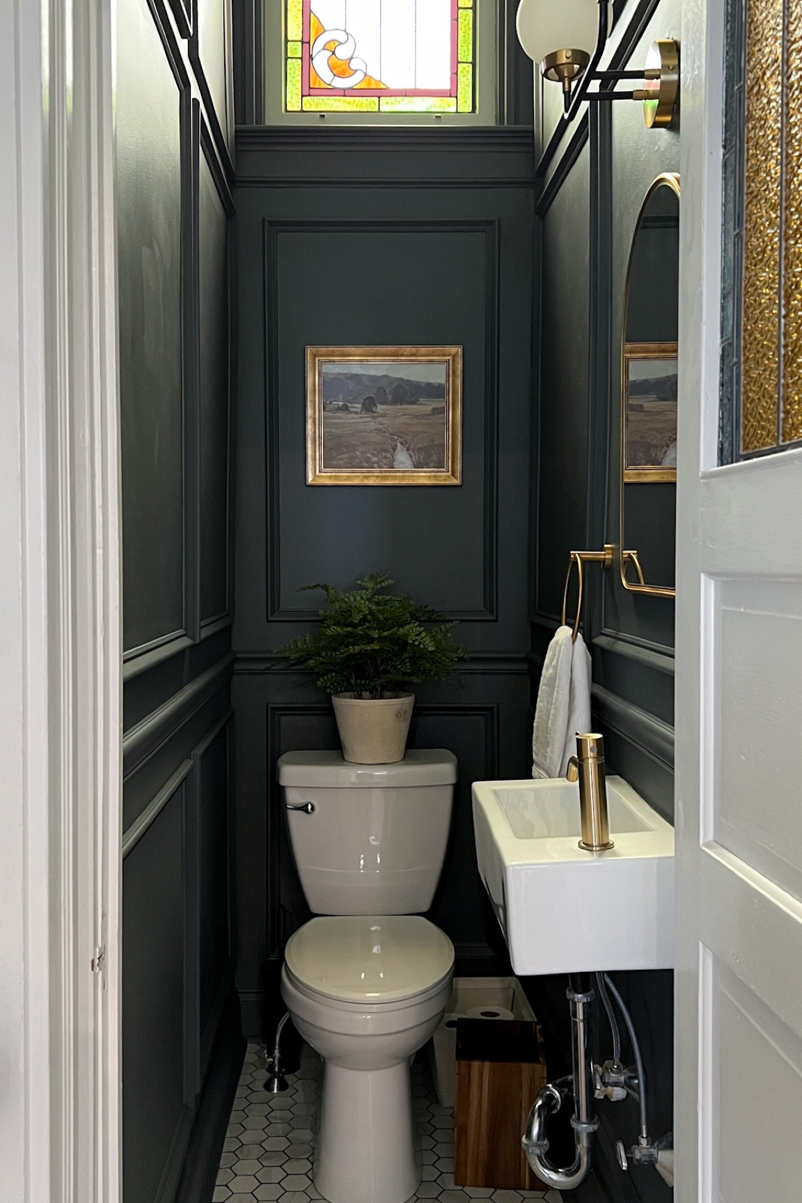 Gray moody powder room with floor-to-ceiling picture molding and gold accents!

#LTKsalealert #LTKFind #LTKhome