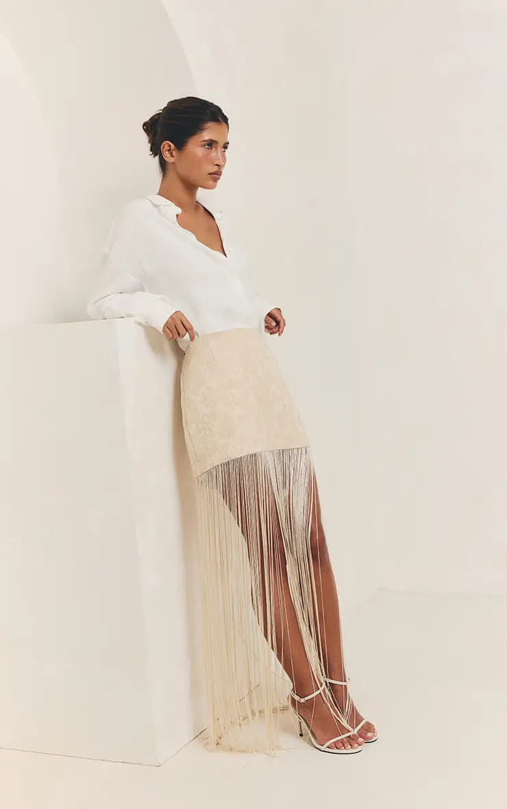 Cream Textured Fringe Tassel Hem Mini Skirt | PrettyLittleThing USA | PrettyLittleThing US