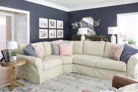 My hale navy living room features a lovely, durable rug, a sectional couch with washable covers, a lovely, inexpensive mirror and a simple gallery wall.

#LTKHome