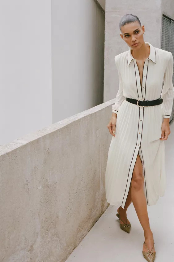 Midi dress with lapel collar and long sleeves. Elastic waistband. Belt detail and pleated fabric ... | Zara US
