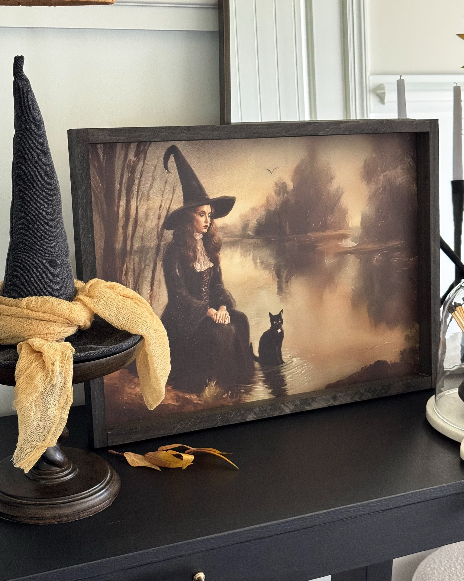 My vintage chic witchy entryway!! found the perfect amount of Witchy!! 🖤
My discount code for the Vintage Witch Print: FARMHOUSECHIC15

Vintage witch print, vintage inspired mirror, vintage barley twist pedestal, vintage clay pot, matches, witches hat, white boucle stools, console table, ottomans, floral throw blanket, taupe vase, toasted eucalyptus, black chandelier, candelabra, glass cloche, fall stems

#LTKstorytime #LTKSeasonal #LTKHome
