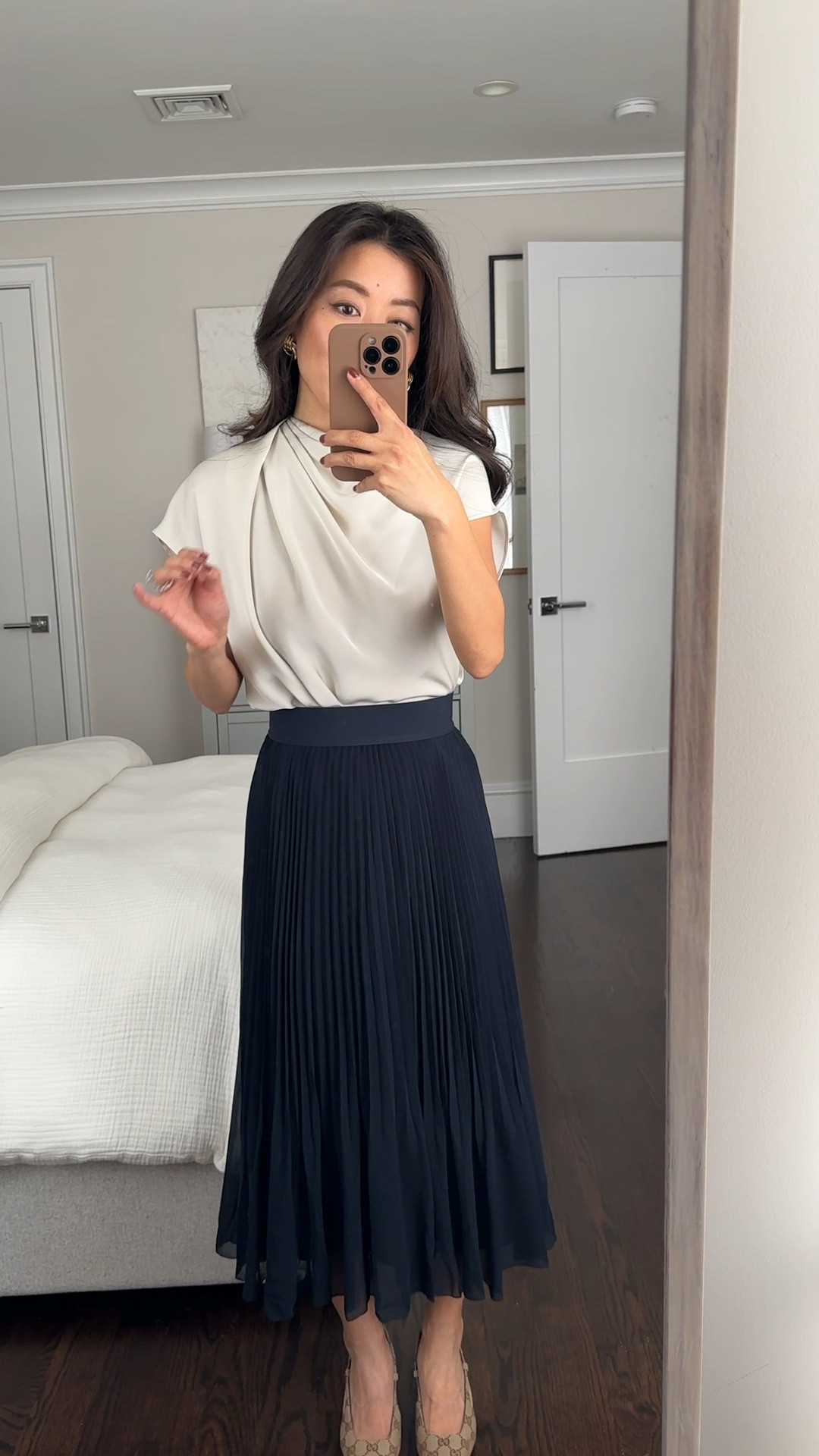 Elegant work outfit and another way to style this gorgeous blouse 

• Aritzia Satin Blouse XXS. Such a luxe blouse with asymmetrical draping! Roomier fit with lightweight fabric that drapes and tucks in fluidly. It’s thin but not sheer with a skin toned bra, however you can wear a neutral cami under for coverage at the side arm holes. Wanting this blouse in the navy blue color next! Have worn this blouse with the Effortless Pants and trouser jeans in recent LTKs for chic business casual outfits.

•Twirl pleated skirt in navy xxs - so pretty! Midi length on petites. More feminine , lightweight and flowier than the average pleated skirt. I have a 25” waist and this is the xxs which sits higher at my natural waist. I also tried Xs which is slightly looser on me, measures 12.25” across the elastic waist band (has stretch)

@aritzia #aritziapartner

#LTKWorkwear #LTKPetite