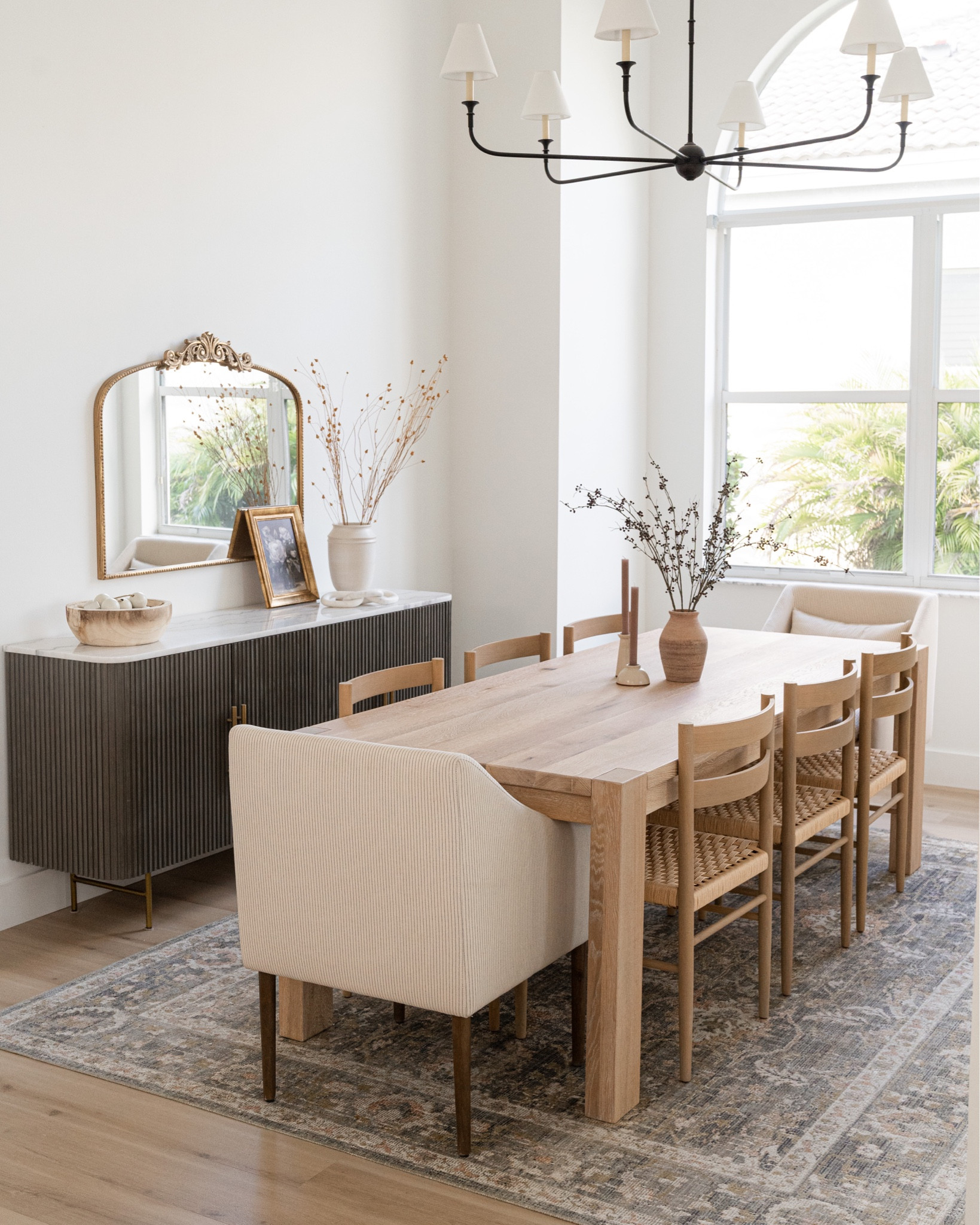 Neutral dining room decor. Love my modern organic transitional dining room! This wood table and wood chairs are my favorite, especially when paired with these upholstered chairs. Love this affordable oriental rug, marble top sideboard, vintage inspired gold mirror and black chandelier



#LTKstyletip #LTKhome #LTKHoliday