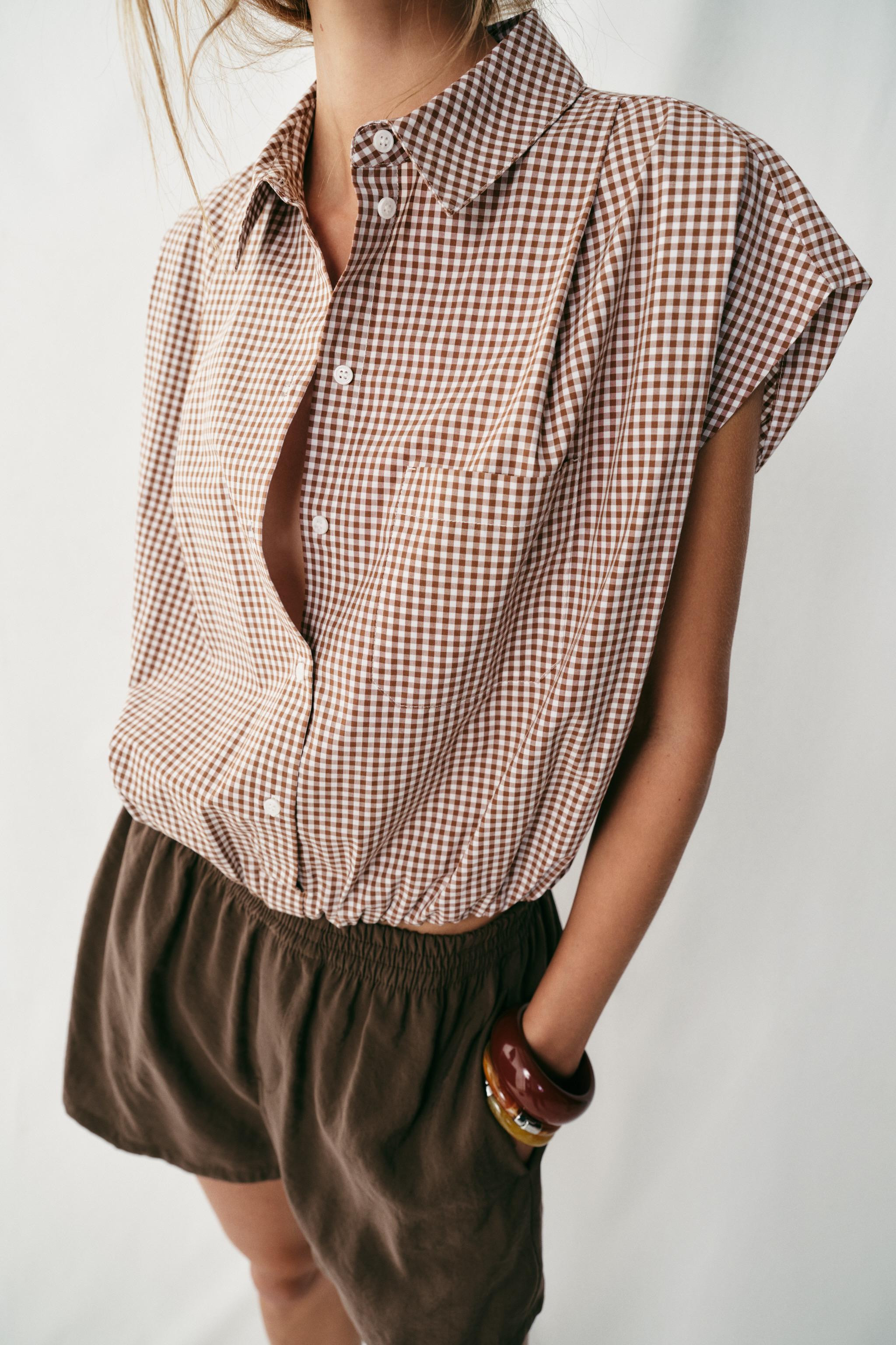 Shirt with lapel collar and sleeveless design with shoulder darts. Front patch pocket. Puffed hem... | Zara US
