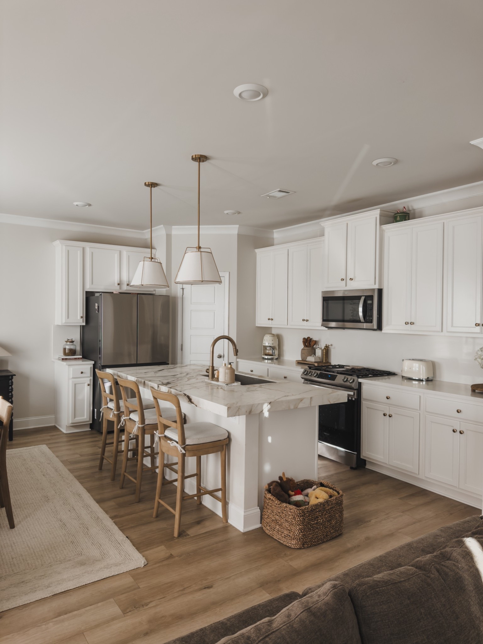 Bright and airy all white kitchen with warm wood counter stools, paired with affordable Amazon cushions for extra comfort (and yes — they’re washable, which is a must around here).

Lately I’ve been really focused on keeping this space clean, minimal, and intentional for the season we’re in. I’m only styling the counters with pieces I actually use every single day — like my Smeg coffee machine, which lives right where it belongs because it’s constantly in use.

This kitchen is all about that balance of aesthetic and functionality. Nothing overdone — just practical, lived in pieces that still feel elevated and calm. It’s proof that you don’t need clutter to make a space feel finished.

#LTKHome #LTKSaleAlert #LTKFindsUnder100