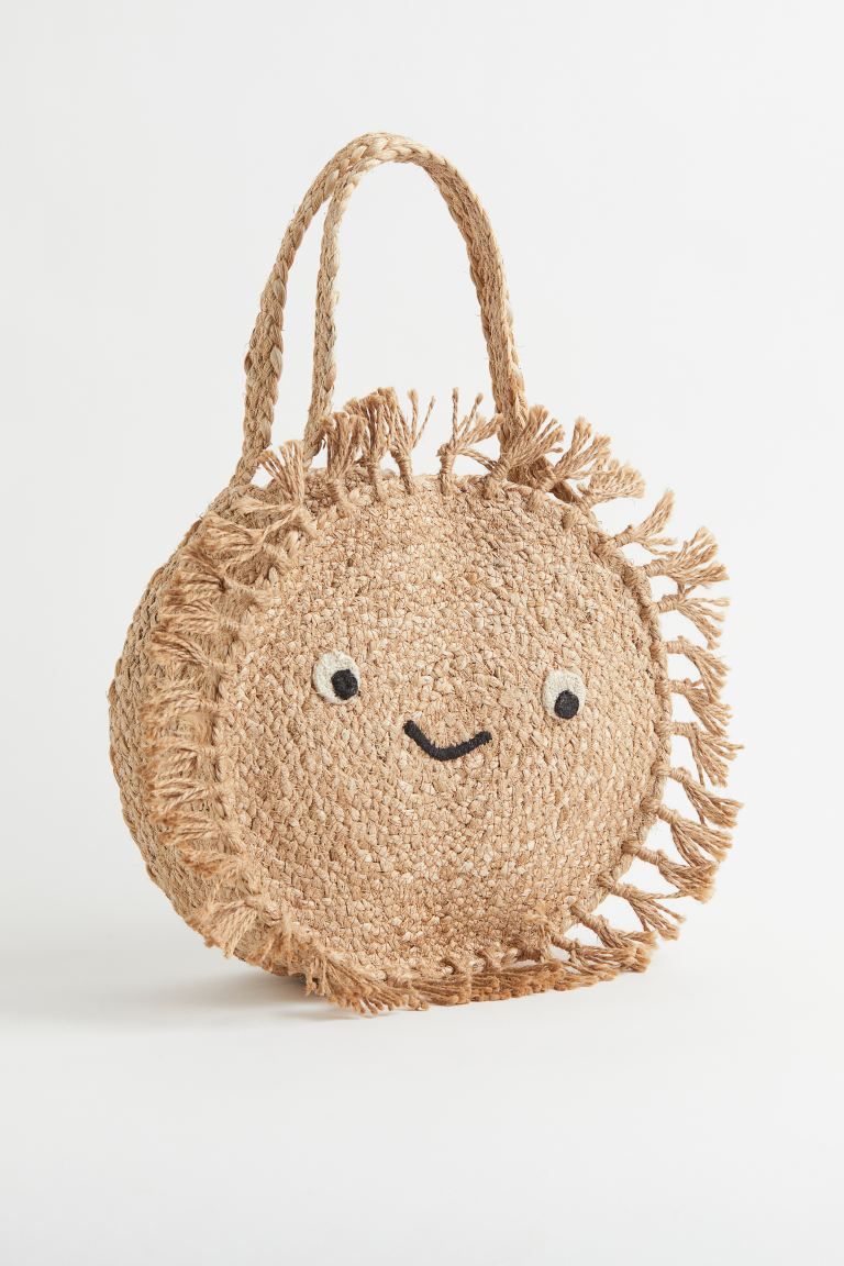 Round beach bag in braided jute with embroidered details and fringe at front. Two handles at top.... | H&M (US + CA)