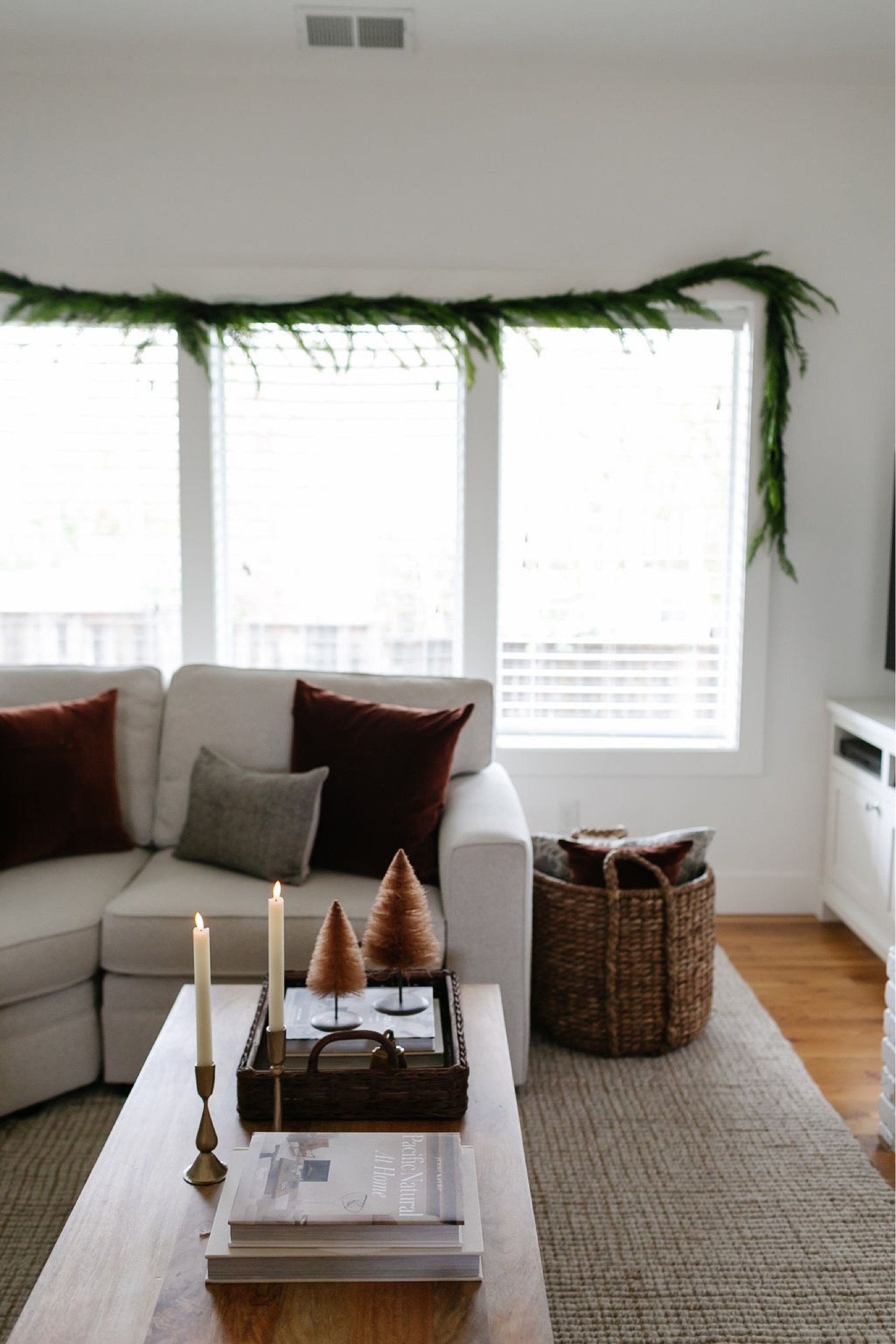 Christmas decor, holiday decor, living room decor, coffee table decor, Pottery Barn wool jute rug, Pottery Barn sectional, wood side table, wood vintage stool, Christmas throw pillows, faux garland 

#LTKhome #LTKSeasonal #LTKHoliday