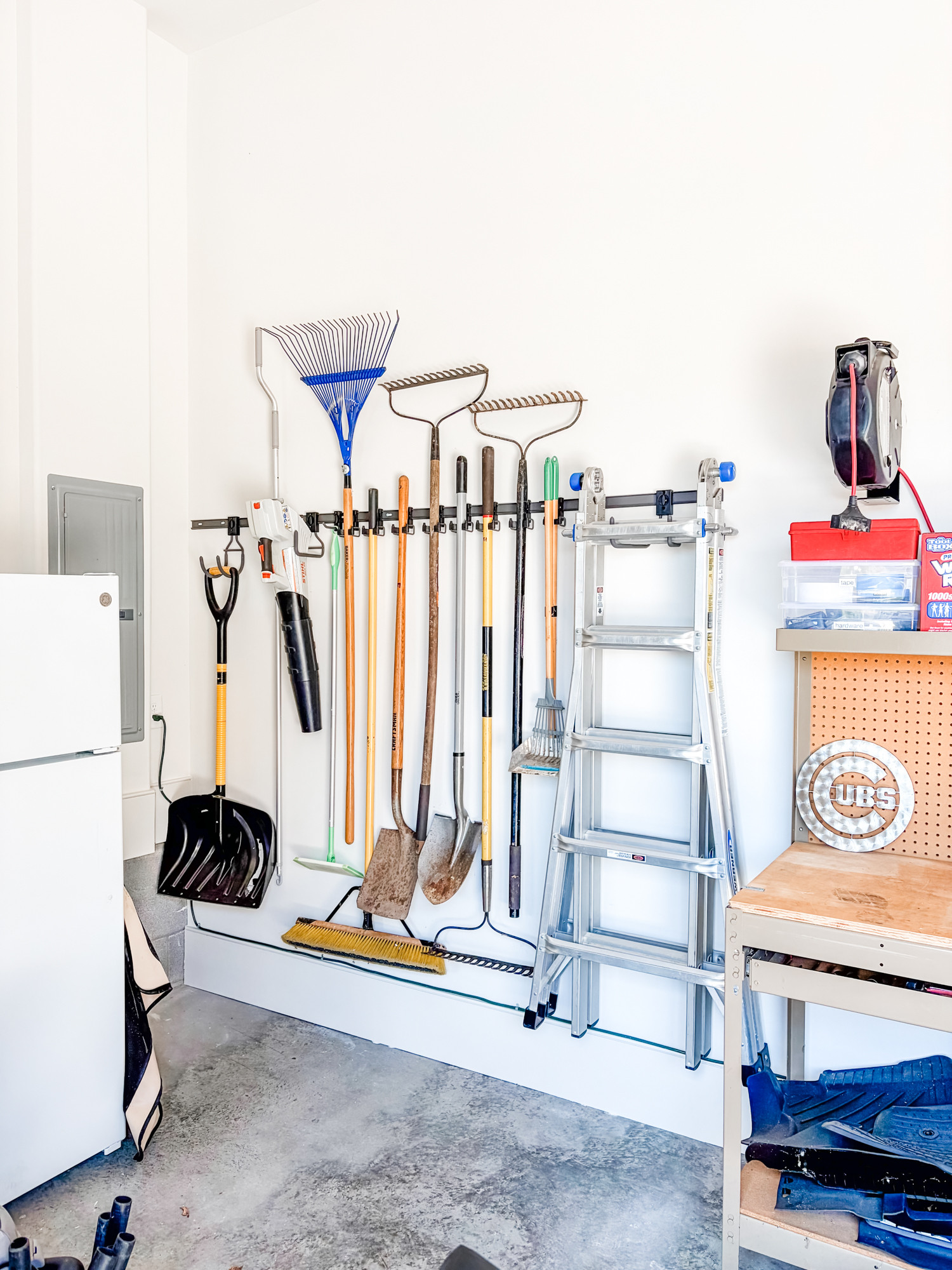 These wall-mounted Elfa wall tracks are a super functional system for garages. They are fully customizable so we're able to configure them with the proper hooks to hold exactly what you've got. Keeping everything off the floor is paramount to an organized garage and we use them on almost every garage we unpack and organize!

 

 