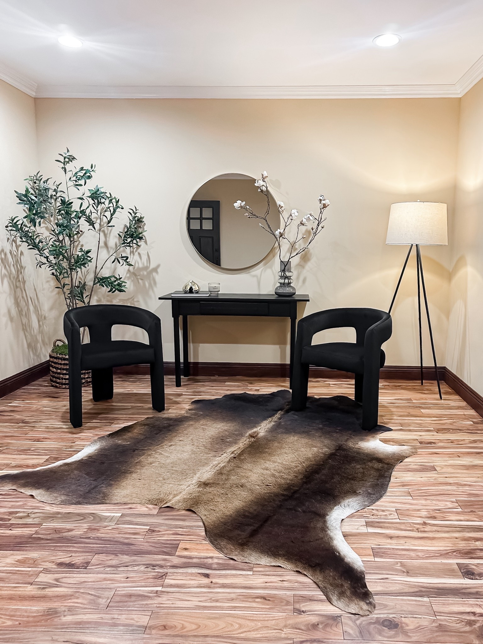 Textural harmony: sleek black accents meet warm wood grain and a natural hide rug.

#LTKHome