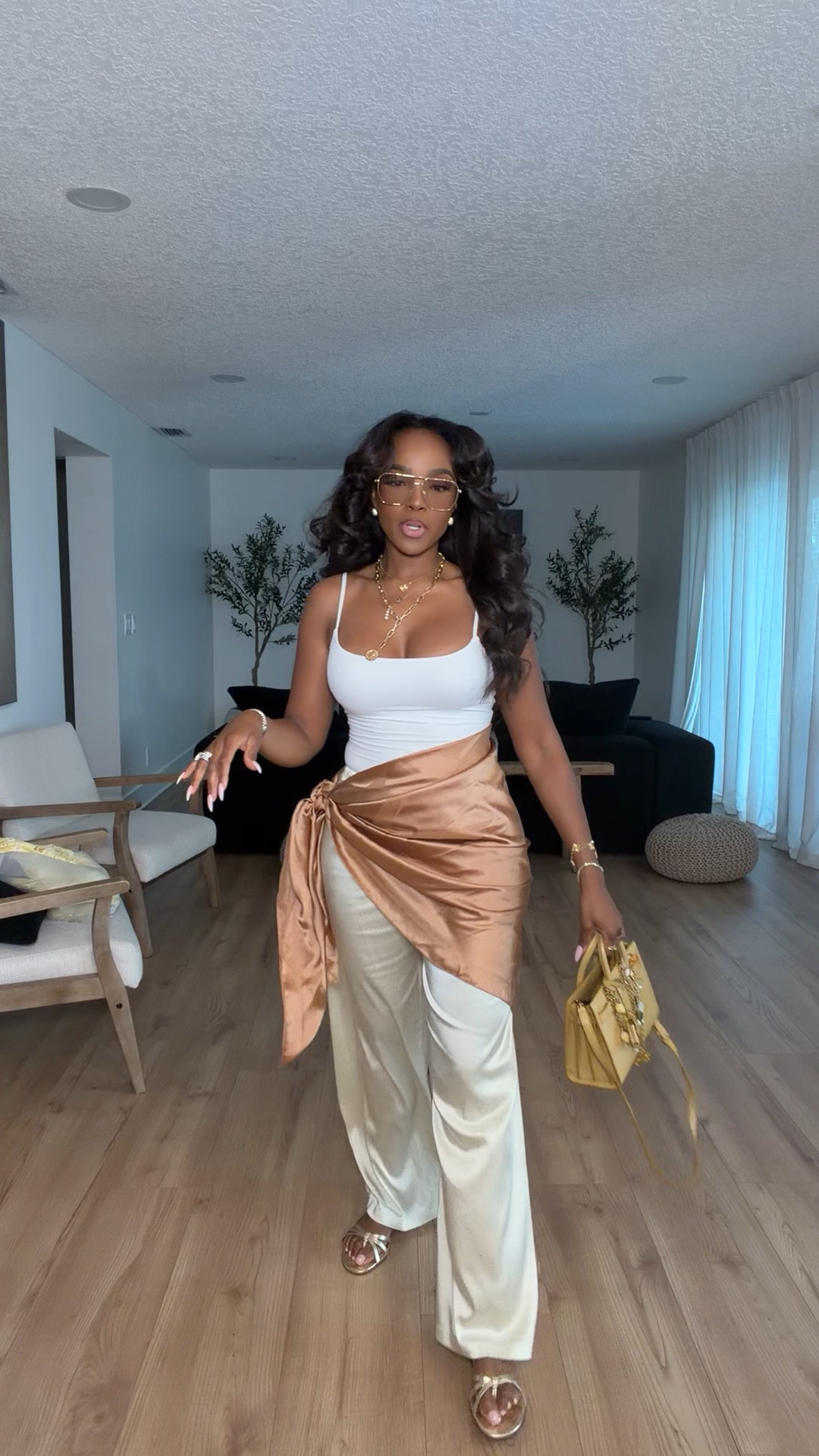 Hi Babes!

This look feels like a luxury vacation outfit without the luxury price tag. The silky champagne pants paired with the white tank create the prettiest neutral palette, while the satin wrap detail instantly makes the entire outfit feel elevated and unique.

I love pieces like this because they look expensive, photograph beautifully, and can easily be styled multiple ways. The soft gold and cream tones are timeless and give that effortless resort-wear vibe that's always in style.

Where to wear this:
• Beachside dinner
• Vacation nights
• Resort getaway
• Rooftop cocktails
• Summer date night
• Cruise dinners

Everything is linked below.

Comment SHOP below to receive a DM with the link to this post on my LTK ⬇

xx Kira | IG: KirasFashionFinds

34D - 27 - 40 • Size Small or 4
