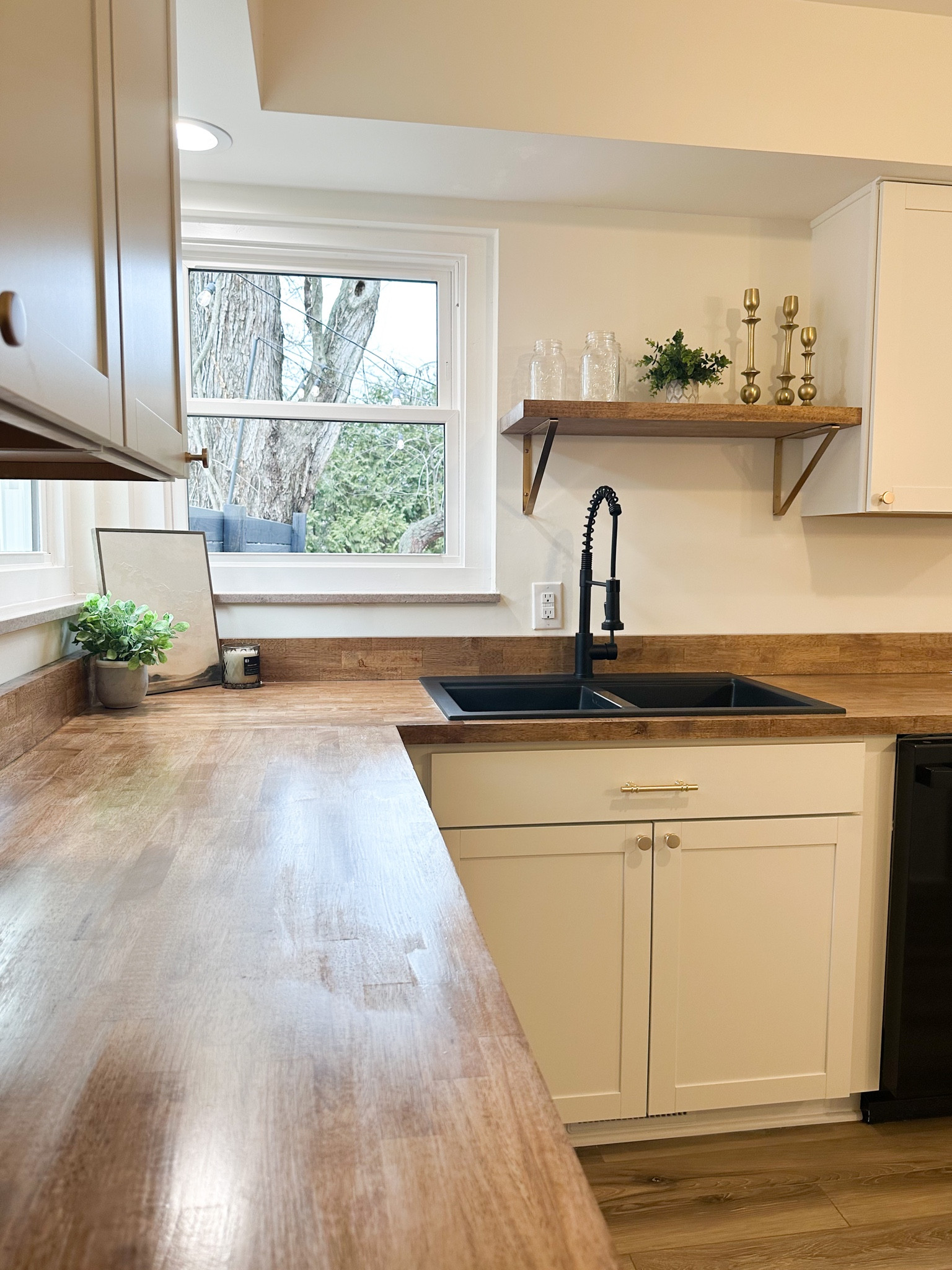 Butcher block counter // white cabinets // kitchen remodel // kitchen pulls and knobs // wood shelf // black sink and faucet 

#LTKFind #LTKhome #LTKunder100