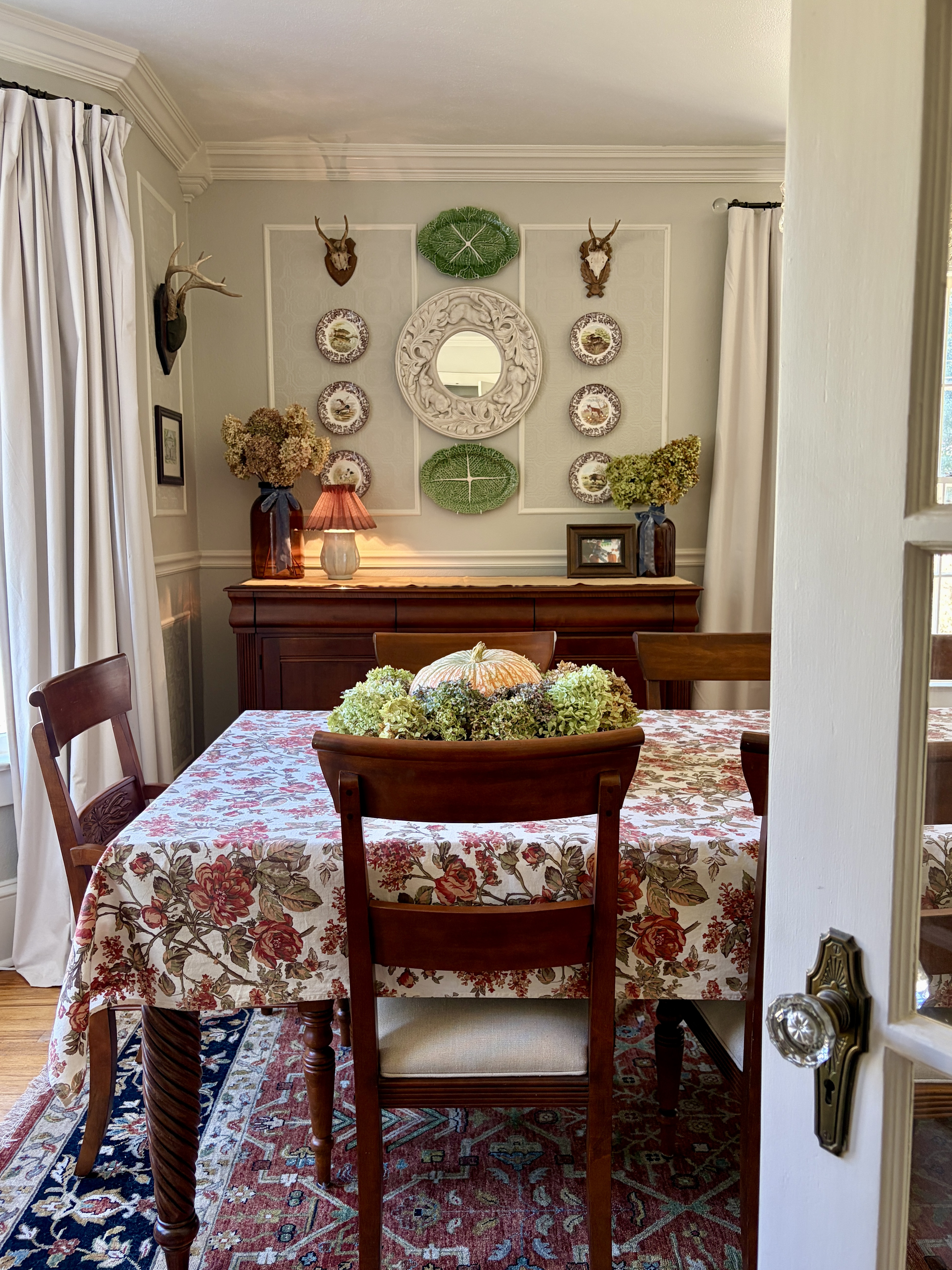 There's no need for a complete overhaul when it's time for seasonal decor. With a few thoughtful additions you can transform your home for the fall seasons.

Dried hydrangeas are added to a grapevine wreath, surrounding a pumpkin. Flowers fill brown glass vases on a buffet. Spode Woodland plates adorn the walls.

For more lifestyle inspiration, follow @belleantiquarian 

 #LTKSeasonal #LTKHome