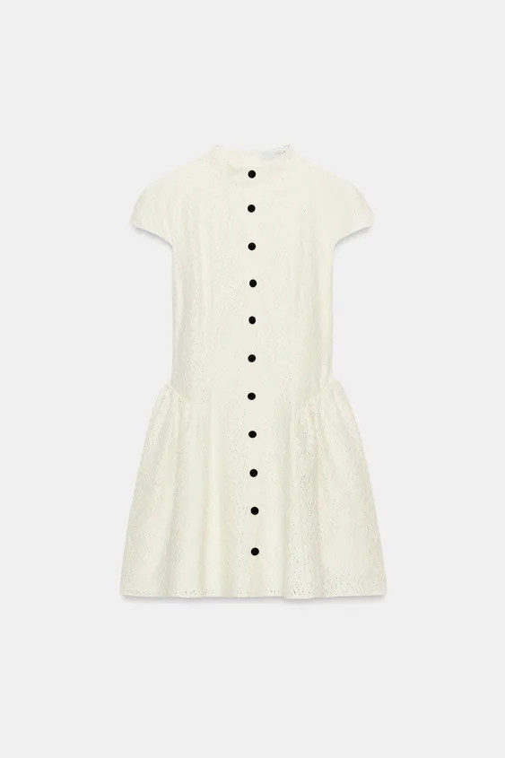 Round neck dress with short sleeves. A-line hem with side gathers and decorative contrasting butt... | Zara UK