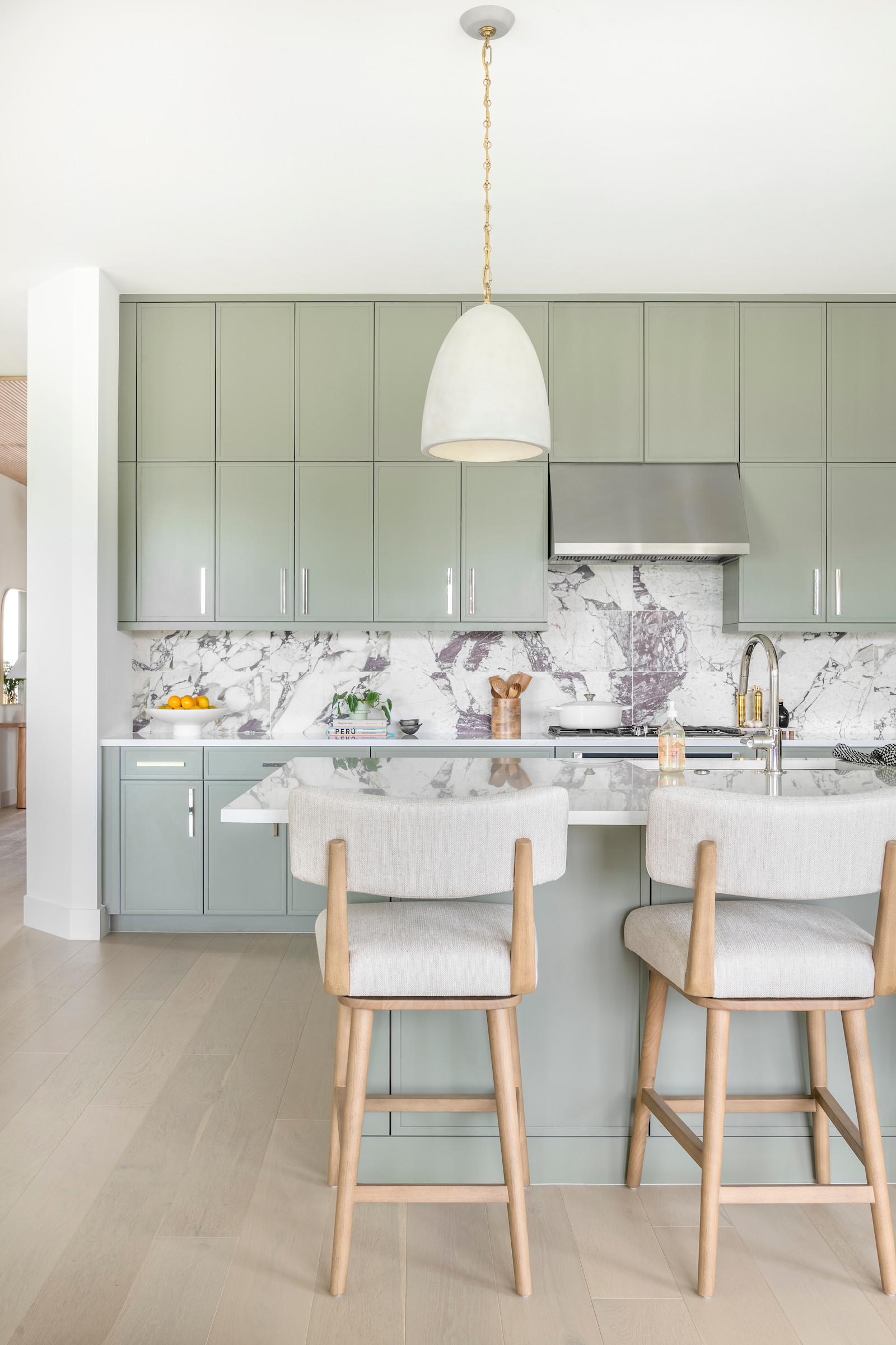 The kitchen in this home got a fresh, minimal upgrade. We asked the builder to skip the backsplash and cabinet pulls, and with that simple tweak, we had a clean slate to work with. The real magic came when we painted the kitchen in a stunning sage/olive color, bringing in a calm yet rich vibe to the space. 

 #LTKHome