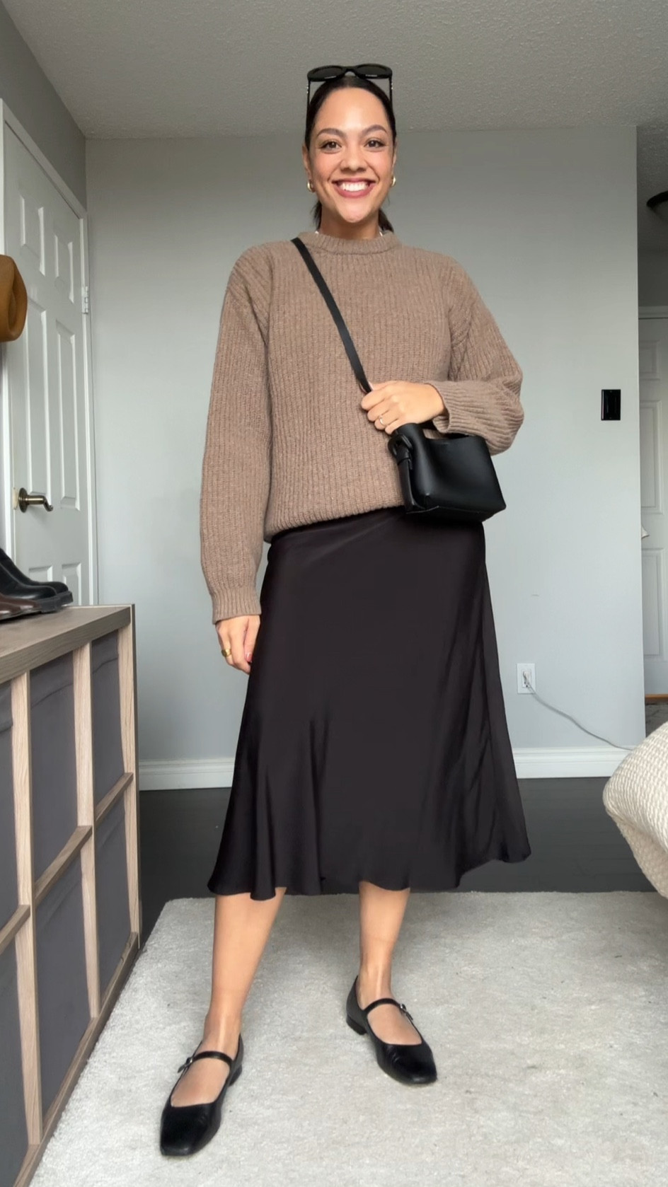 Ways to wear a crewneck sweater! Details below:

-Poppy Barley crewneck sweater in the colour dune. Made with 100% superfine lambswool. Super soft and versatile! I’m wearing a large. 
-Dynamite black midi skirt, I have a small. 
-Poppy Barley black leather Mary Jane flats. 
-Arket black mini crossbody bag  
-COS gold mini hoops. 
-Celine Triomphe 52mm sunglasses in black acetate. 

#LTKstyletip #LTKfindsunder100 #LTKSeasonal