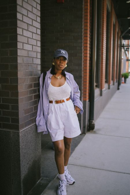 Casual mom outfit school pickup new balance 530 sneakers with white Bermuda shorts and white tank top. Pin stripe button down and NYC baseball cap. 

#LTKStyleTip #LTKFindsUnder100