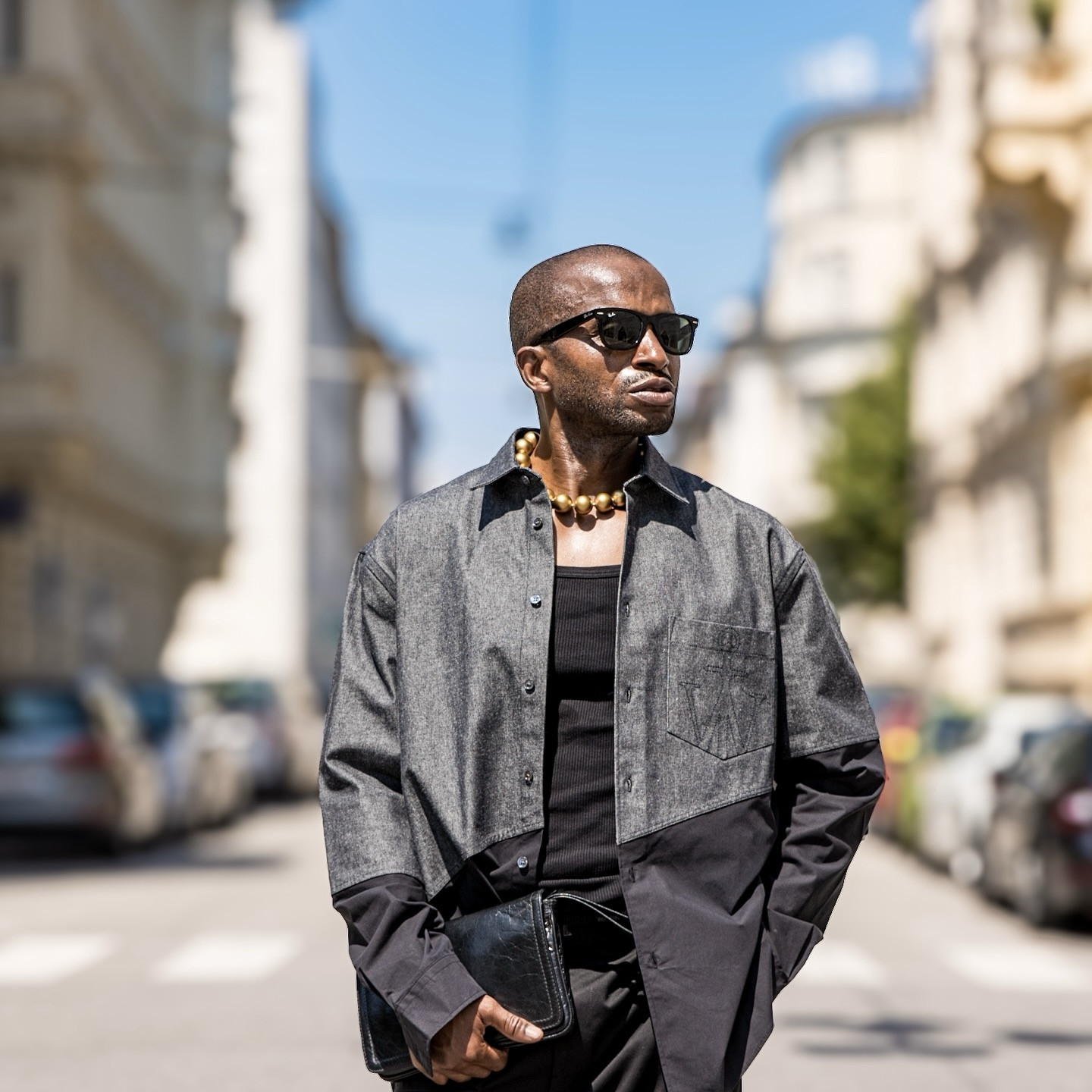 I’m sharing with you all my latest outfit as I love experimenting with fashion to create unique and bold looks, and this one is definitely a favourite. I wore a black-greyish shirt from JW Anderson and a black tank top from Hugo Boss. I kept the base of the outfit simple and classic. I chose black pants with a relaxed fit from Palm Angels. I also decided on black chunky boots from Balenciaga. They add an edgy touch and make a bold statement. I added a gold bead necklace to add a bit of shine and elegance to the look. I carried a vintage black clutch, which is both practical and stylish. To complete the look, I wore black Ray-Ban sunglasses that were timeless and cool. I love the way this look came together, with its mix of sophistication and edge. Please let me know what you think in the comments below.#PhotoshootStyle #FashionInspo #JWAnderson #HugoBoss #PalmAngels #BalenciagaBoots #RayBanSunglasses #VintageClutch #GoldBeadNecklace #OOTD #EdgyFashion #SophisticatedStyle #FashionBlogger #DailyOutfit #SelfExpression #GayNigerian #BoldFashion #TrendyLook #StyleJourney #Fashionista