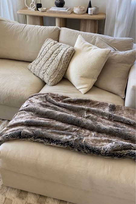 the coziest spot on my couch!! the throw pillows are so chic and the throw blanket is SO COZY. 

#homedecor #fauxfurblanket #boucle #throwpillows #knotpillow #beigecouch #whiteoakconsole #woodconsole 

#LTKstyletip #LTKhome #LTKFind