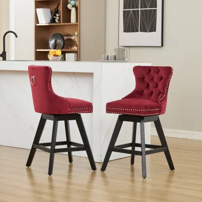 Wine red velvet swivel bar stools with button tufting and nailhead trim, set of 2