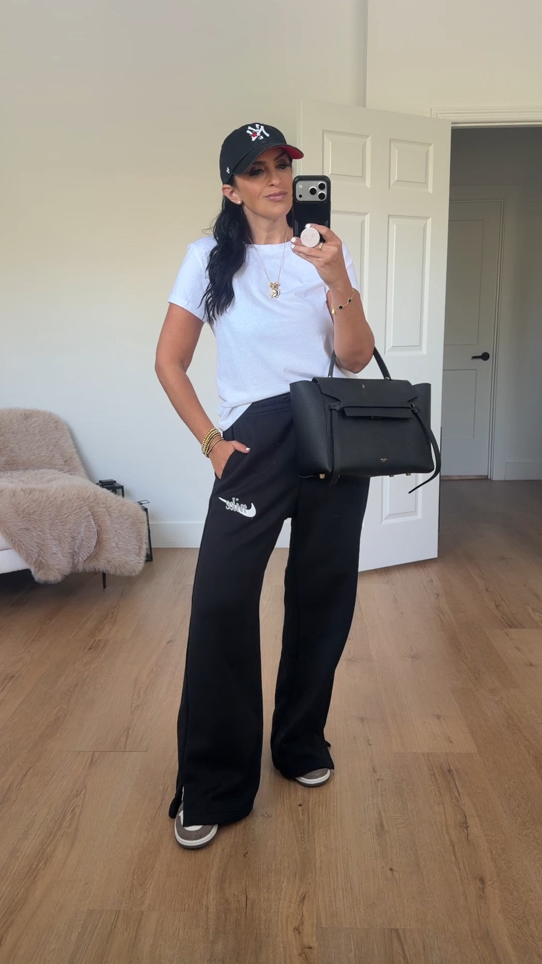 Nike sportswear phoenix fleece women’s high waisted wide leg logo pants black summit white wearing size medium 